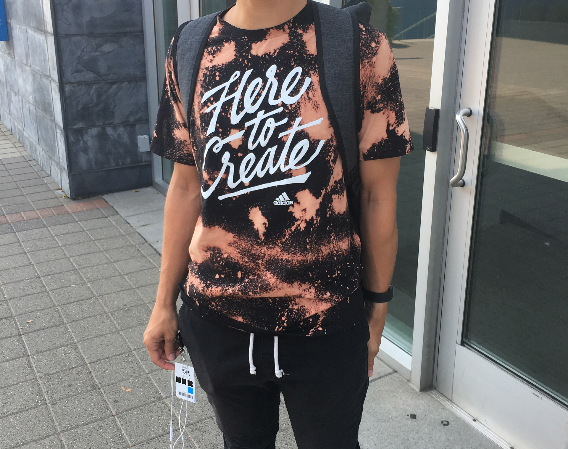 Photograph of adidas employee on campus toting his bleach-customized Here to Create t-shirt.