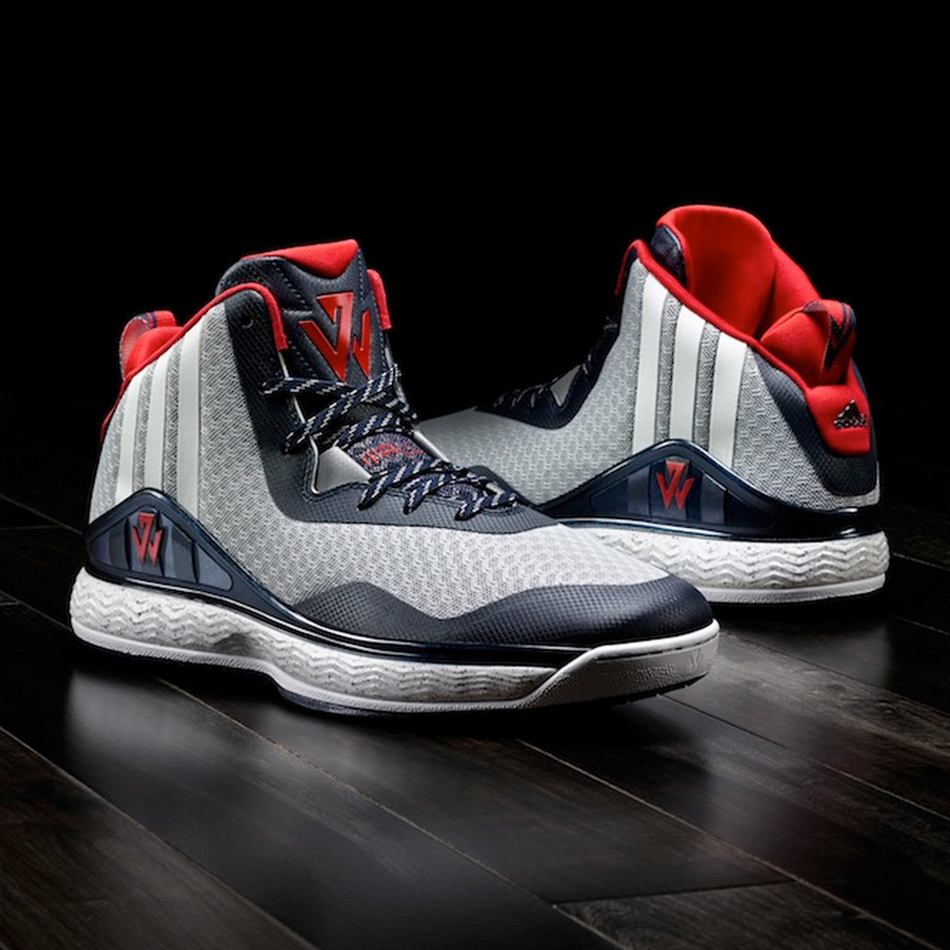 Image of footwear J-Wall 1 in red, blue and navy toting the new logo on the tong and side.