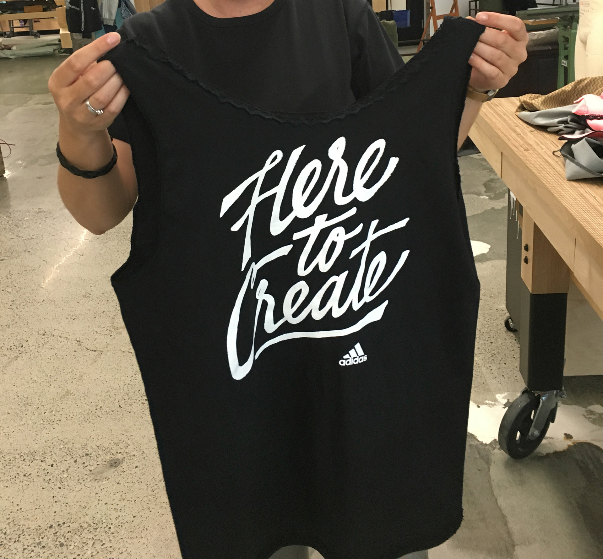 Image of person customizing their Here To Create t-shirt by converting it into a tank top with black lace trim.