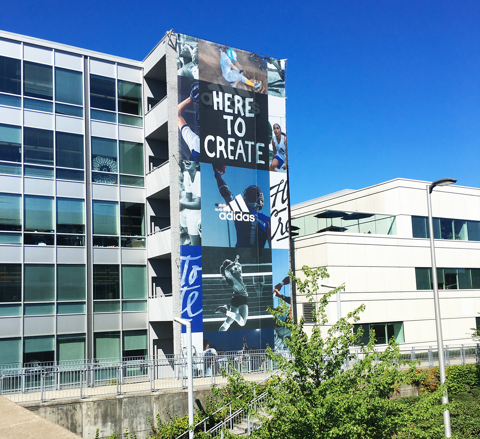 Photograph of large "Here to Create" billboard outside of the Adidas North American Headquarters in Portland, Oregon.