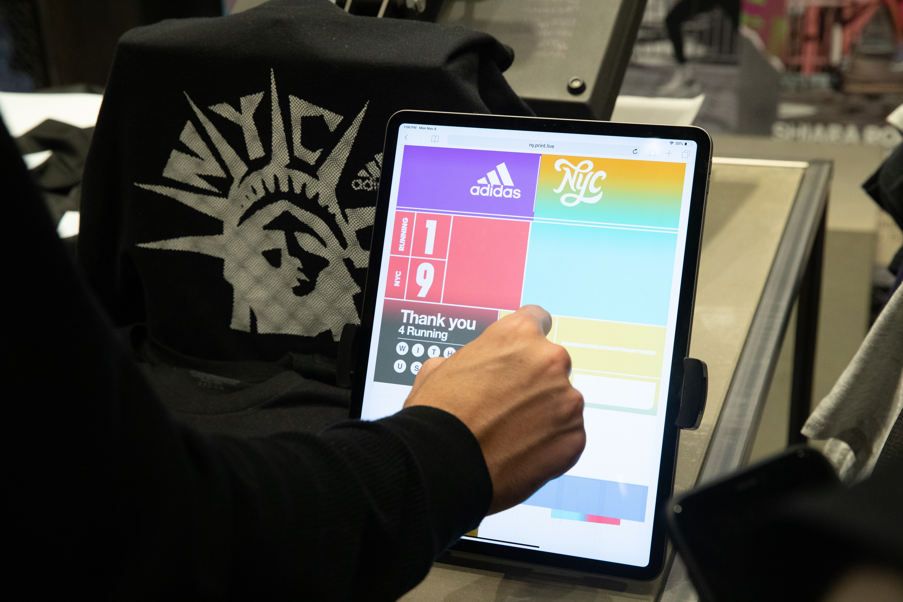 Photograph of a person using the touchscreen to color up their graphic.