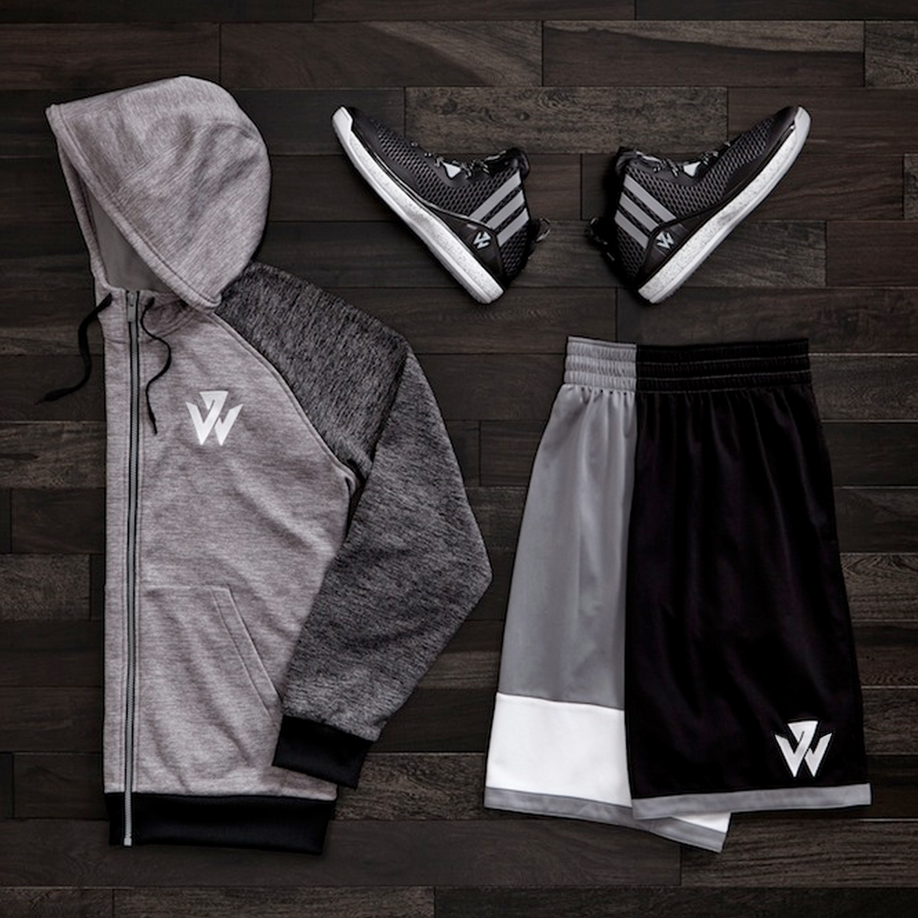 Photograph of J-Wall 1 shoes, shorts and hoodie in black and gray toting the new logo.