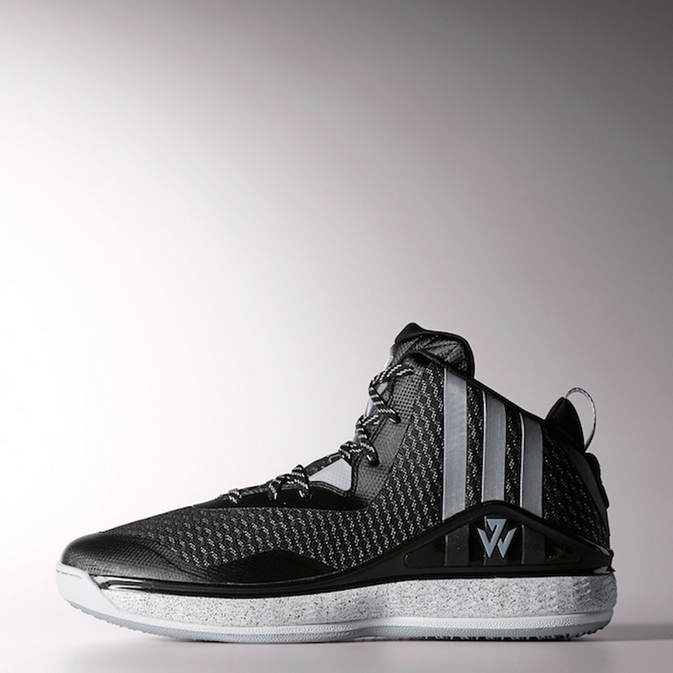 Photograph of side profile of J-Wall 1 shoe in black and gray toting the new logo.
