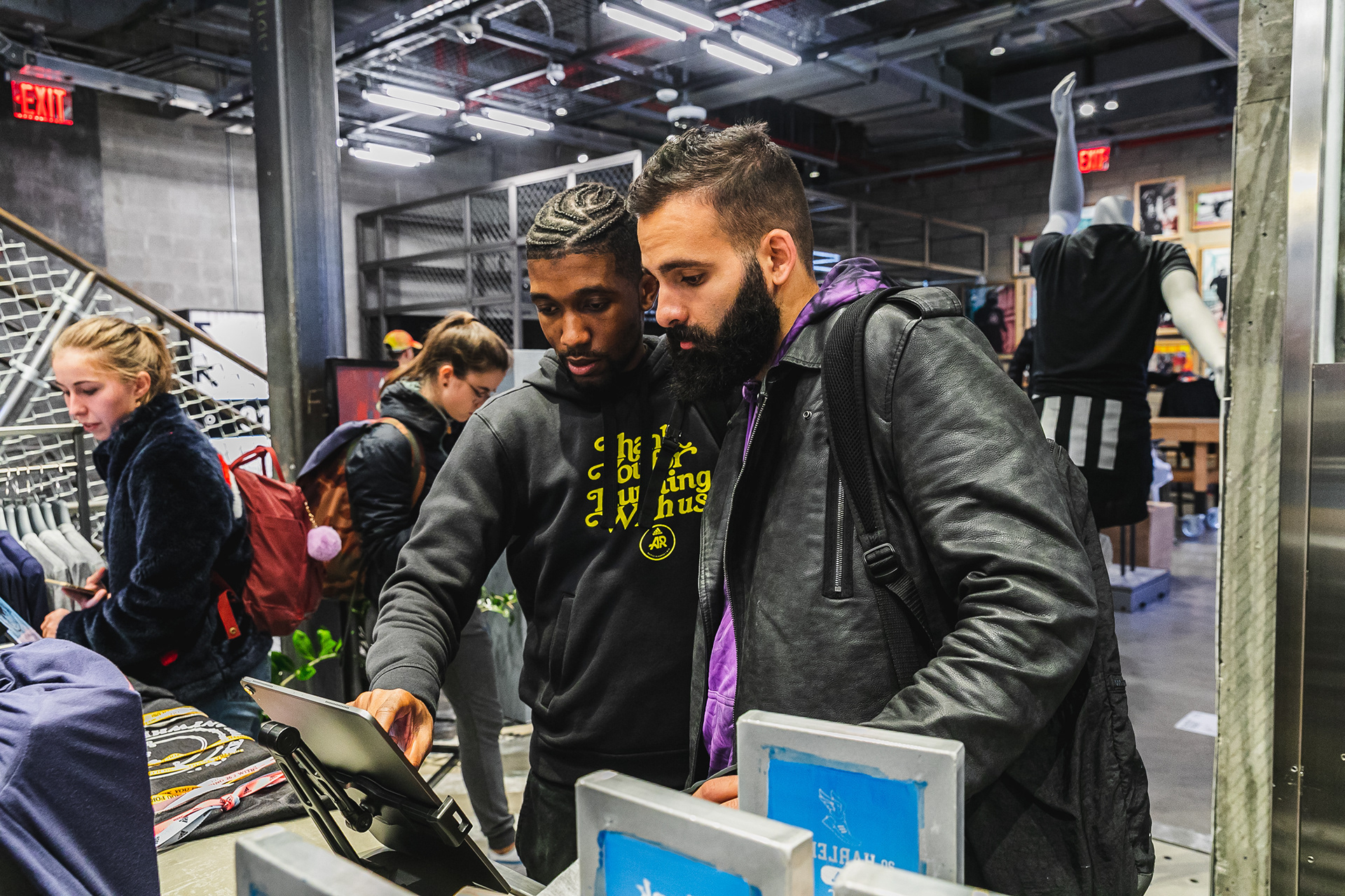 Photo of someone helping somebody customize their gear.