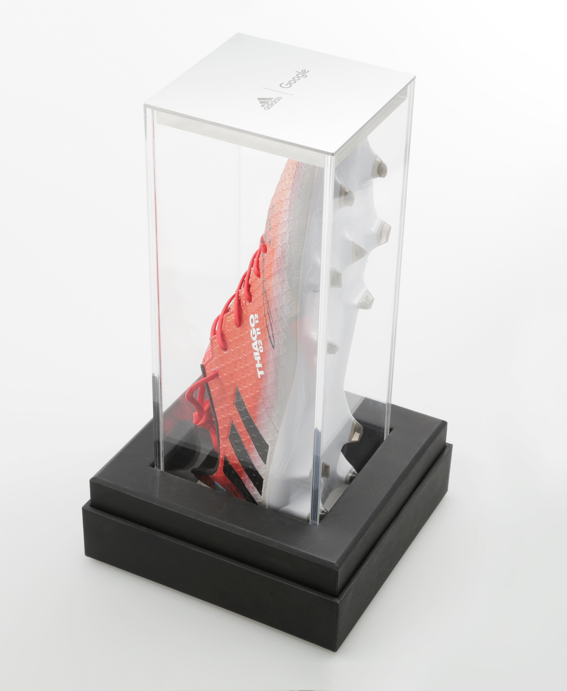 Photograph of top of display case when positioned vertically, highlighting the adidas x google engraving on the aluminum end-cap.