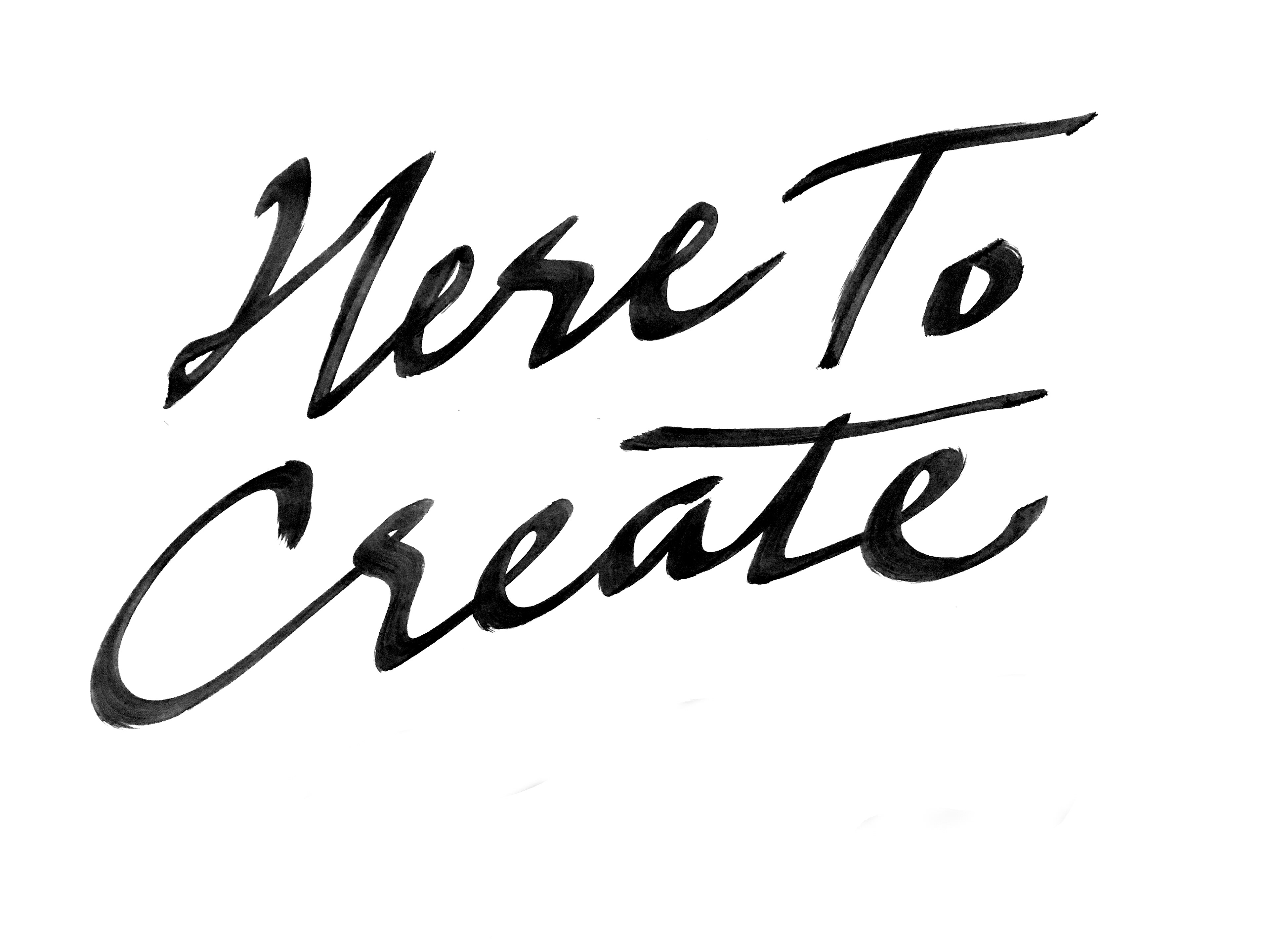 Photograph of chisel-tip brushed lettering reading "Here to Create."