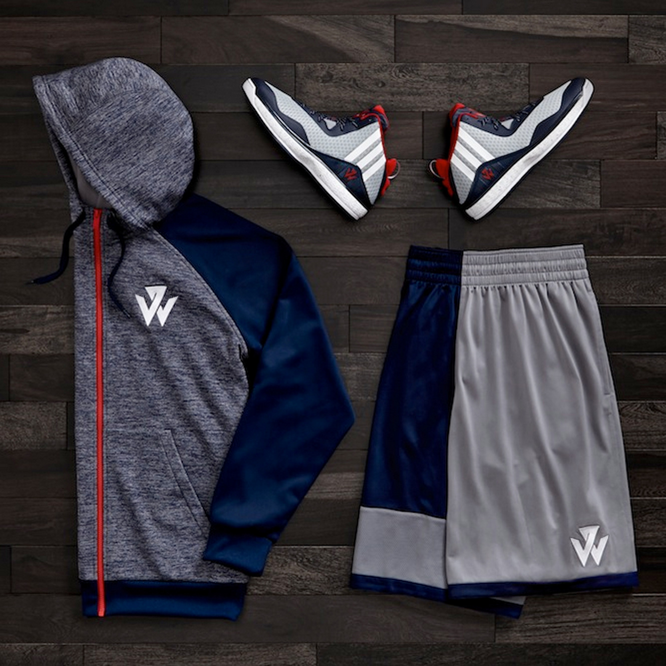 Photograph of J-Wall 1 shoes, shorts and hoodie in red, gray and navy toting the new logo.
