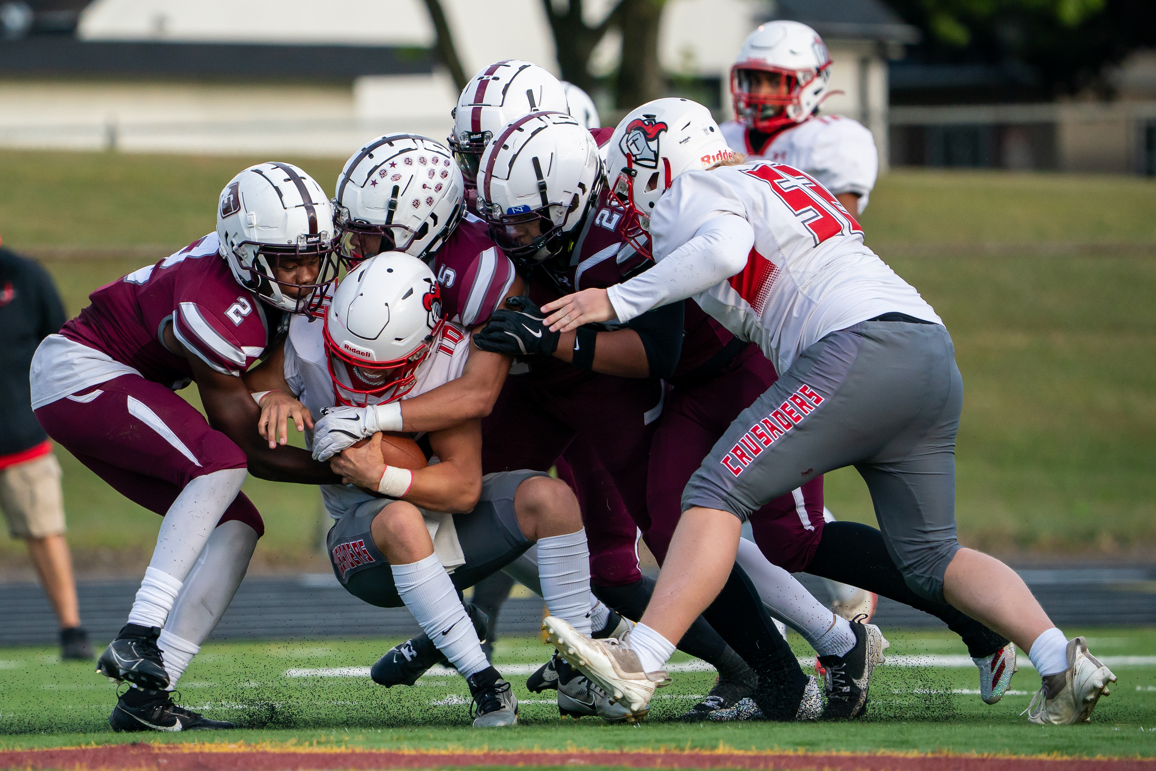 St. Paul Johnson football players tackle St. Croix Lutheran’s  quarterback Villiam Andersen (10) at Harding High School in St. Paul on Friday, Sept. 5, 2025.
