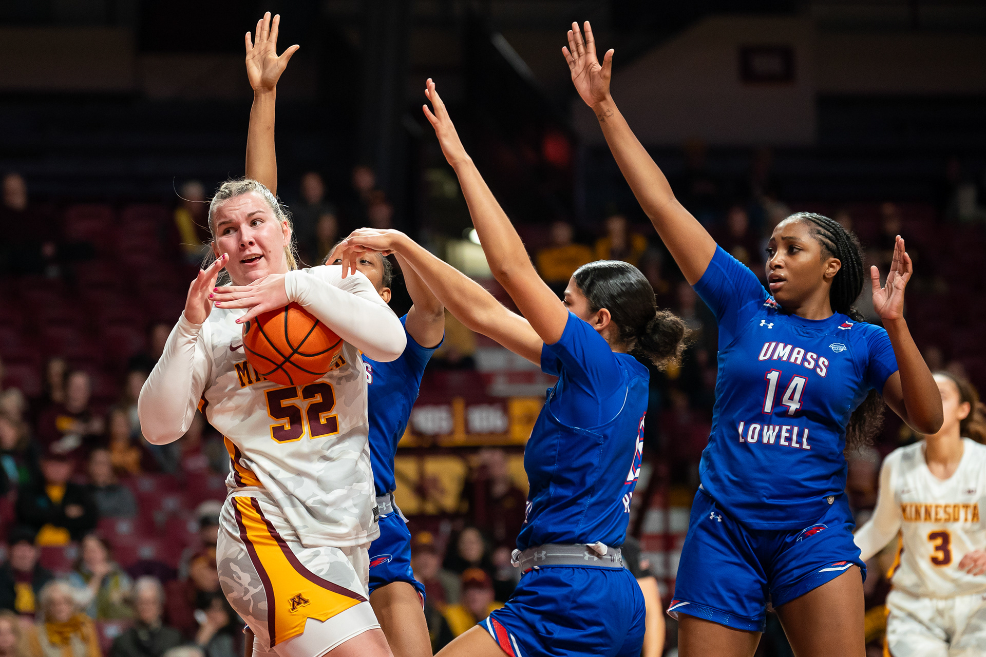 University of Minnesota athlete Sophie Hart pulls the basketball away from University of Massachusetts Lowell players in Williams Arena in Minneapolis, Minn. on Nov. 12, 2024. Minnesota lead the game with a score of 82-37.