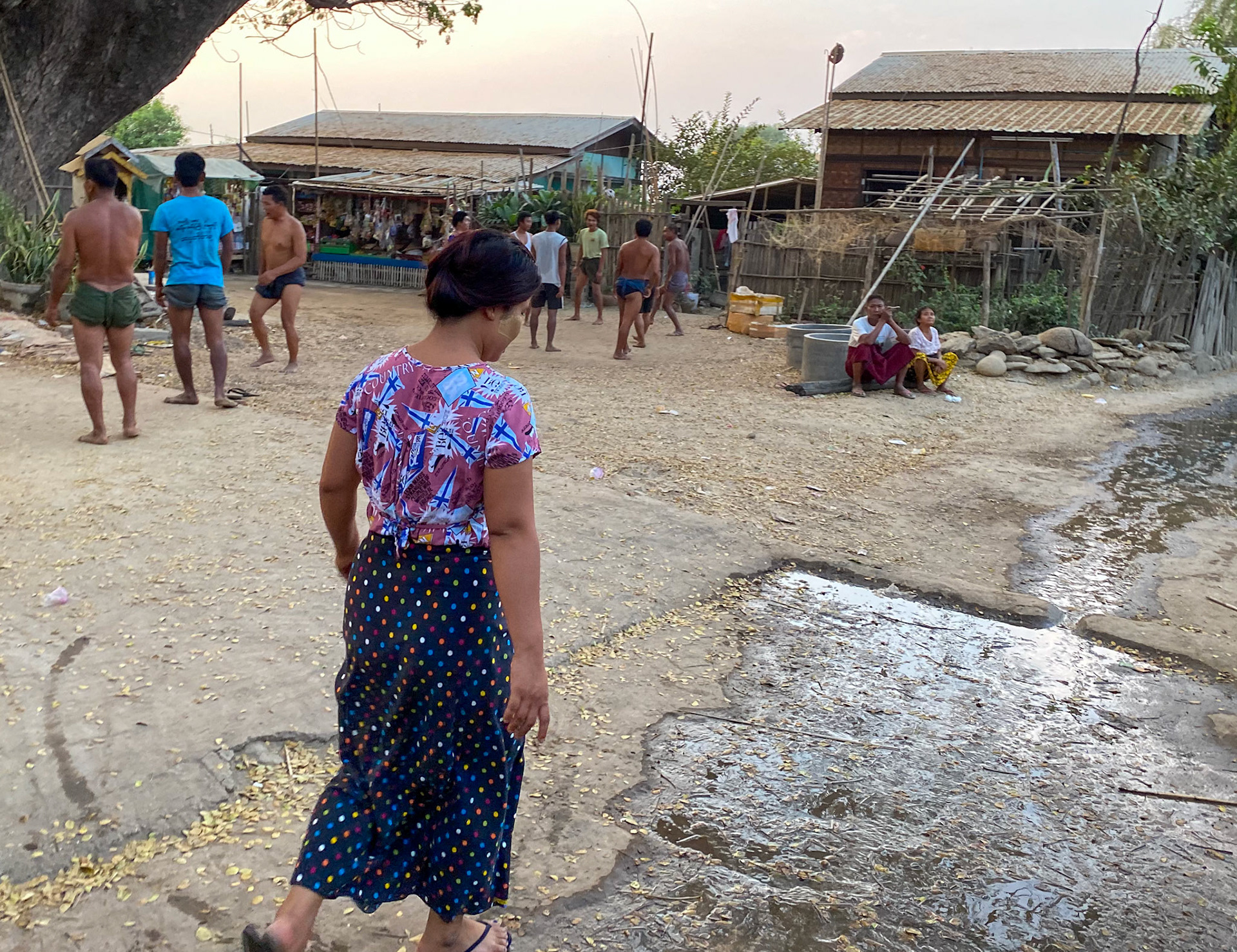 ATZ taking us through the village main square where men play a ball game
