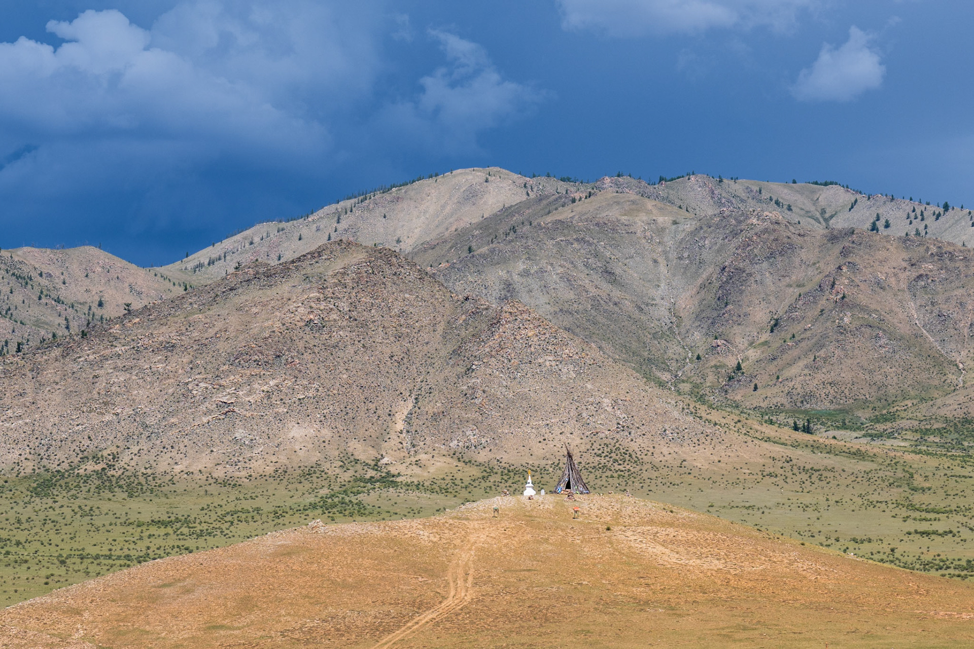 The ovoo relates to ancient Mongolian belief, traditional worship, Buddhist ritual, and one of the ways to call people to protect and be proud of nature. It’s also called Creepy Teepee in the “Grand Tour Mongolia” 🙂. Most of them were on top of a hill. The reason there are many is that they can represent different things, like protection from natural disaster, protection for travelers or paying respect to a mountain pass or on the top of marvelous, sacred, and spiritual mountains.