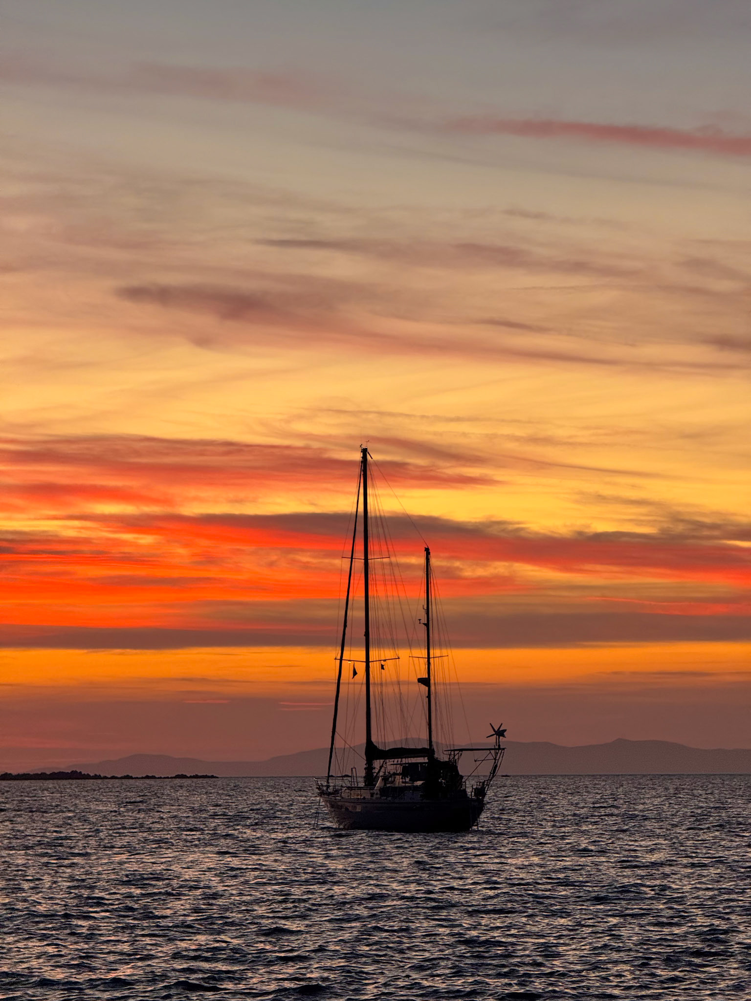 Our sailboat, Rode Trip, in the sunset. Picture taken from the bars in front 🙂