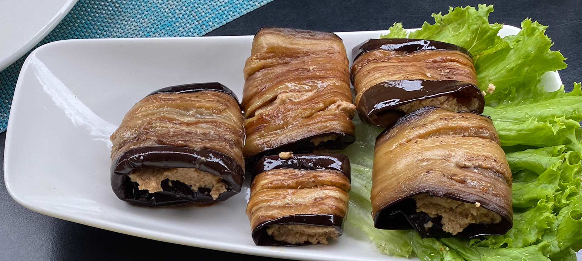 Badrijani Nigzvit is a Georgian food that consists of fried eggplant rolls with walnut (sometimes mixed with garlic) filling.