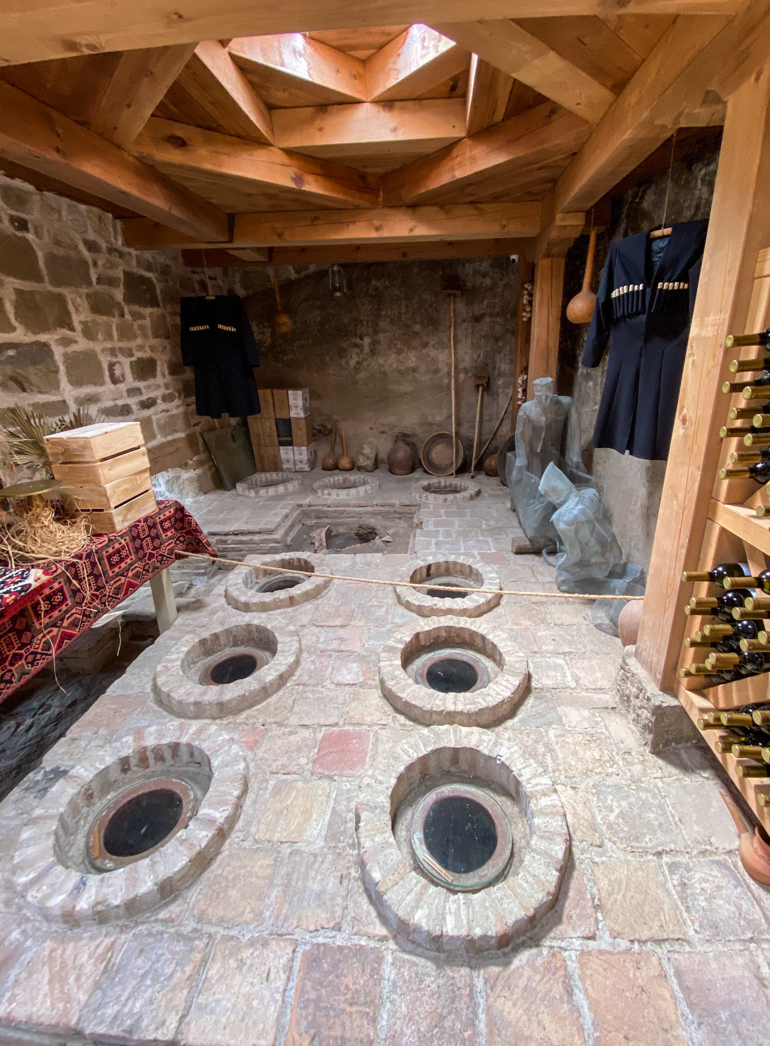 Wine is stored in clay vessels called kvevris, burying them in the ground to maintain a suitable temperature for serving.