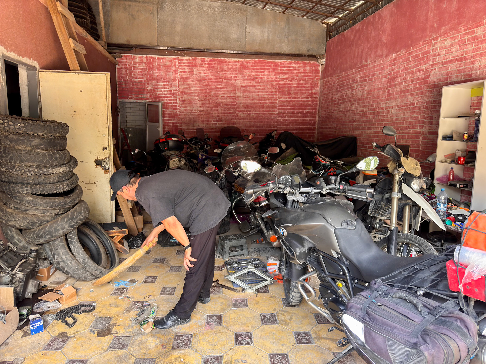 Aziz moved a couple of bikes and “cleaned” a bit of space to allow us to work in the shade of his workshop