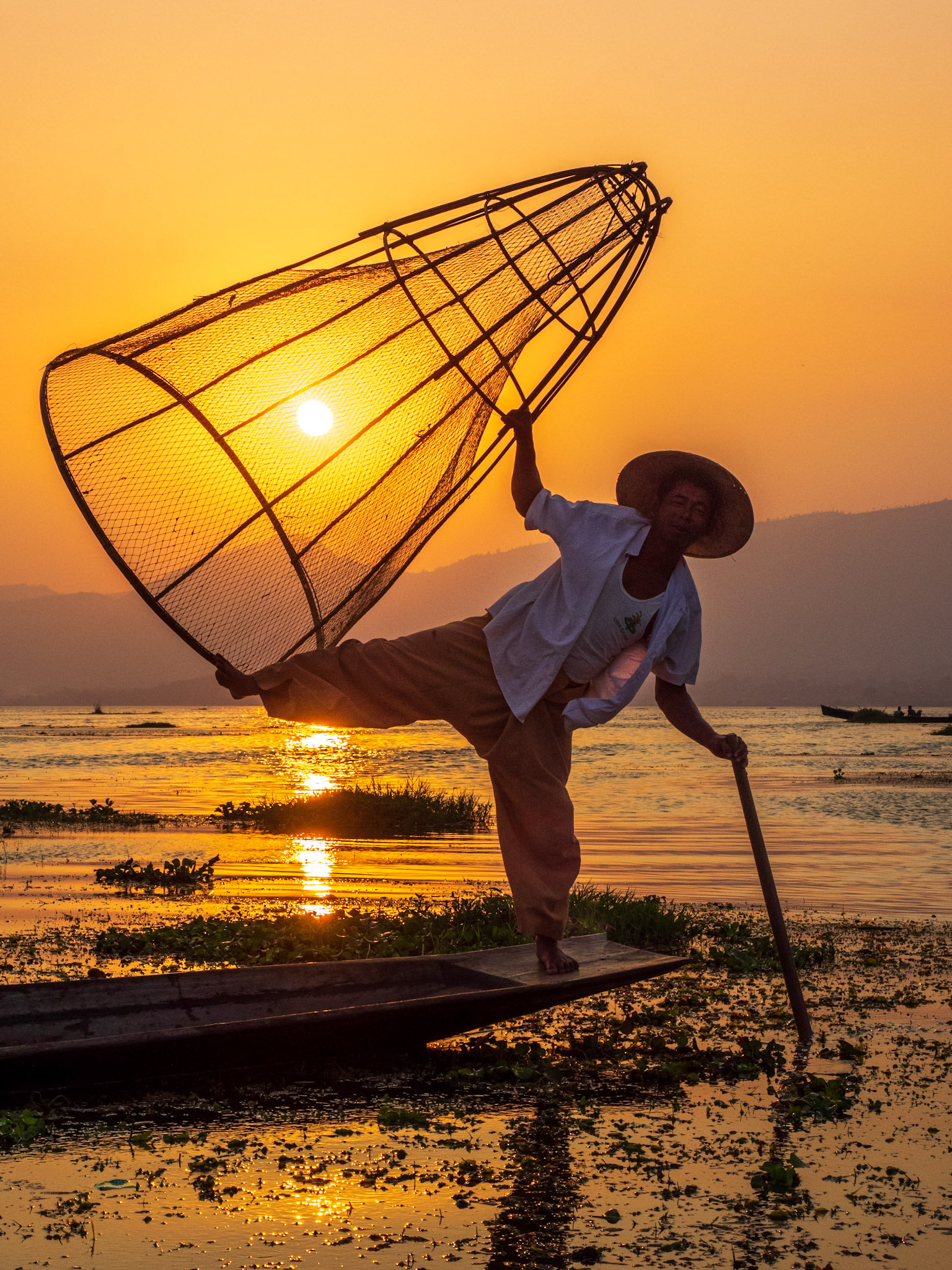 These cone-shaped nets are made from bamboo and have a small net inside. Fishermen trap the fish by throwing the cone-shape nets into the water, pressing on it with their feet so it sinks to the bottom where the fish are.