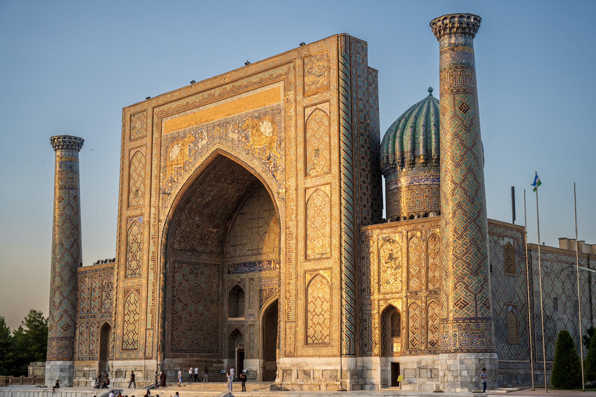 The East building of the Registan illuminated by the sunset