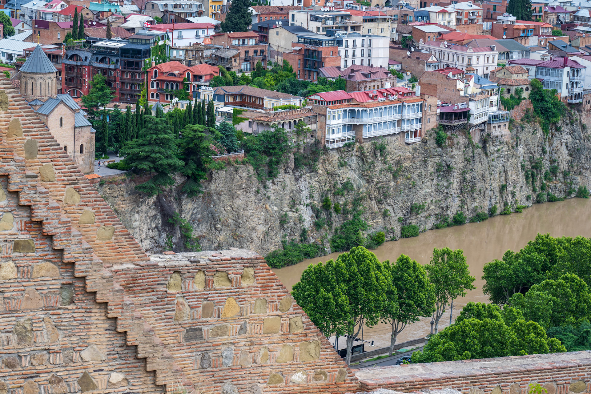 View of the river and the houses on top of the cliff, from the Narikala Fortress