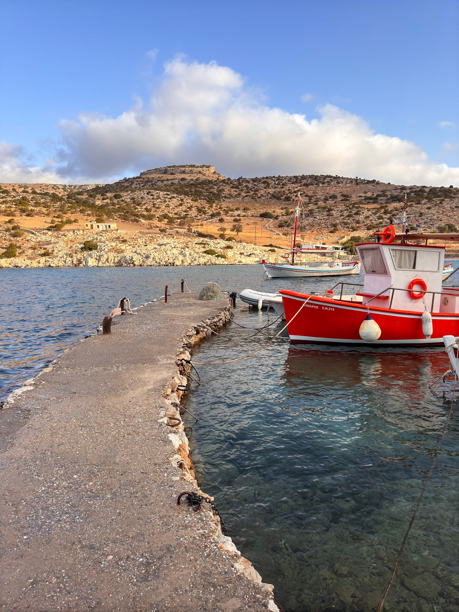 Panormos bay, with a rock citadel on the hill behind