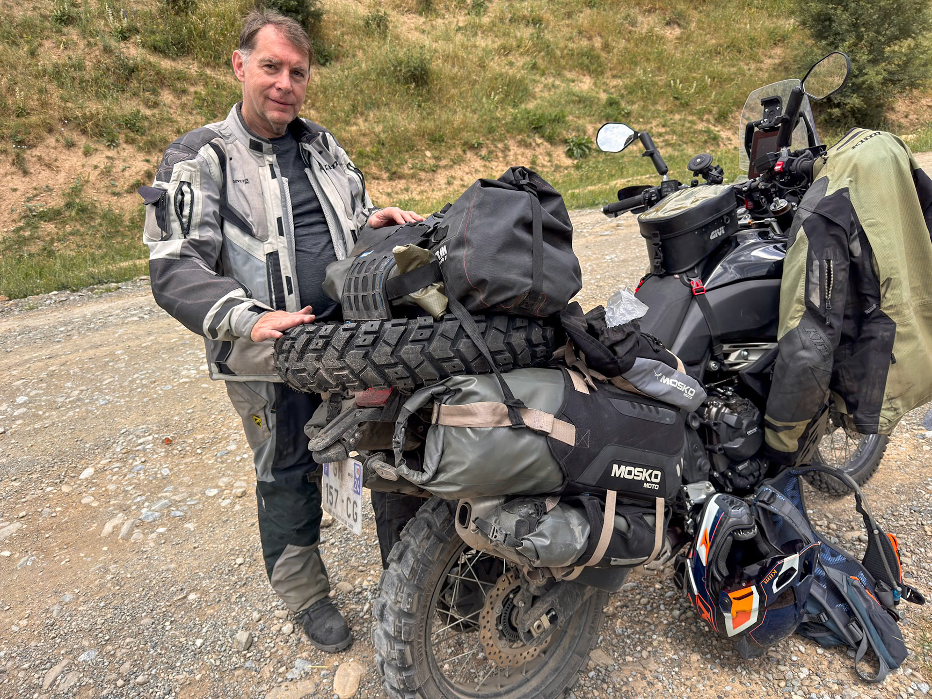 It’s always cumbersome to carry a tire on a motorcycle and all the rocks of the dirt road did not help