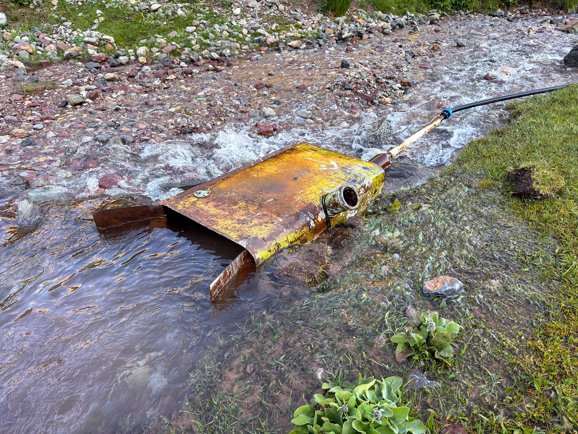 Ingenious way to capture fresh water and pressurize it way down in the yurt camp
