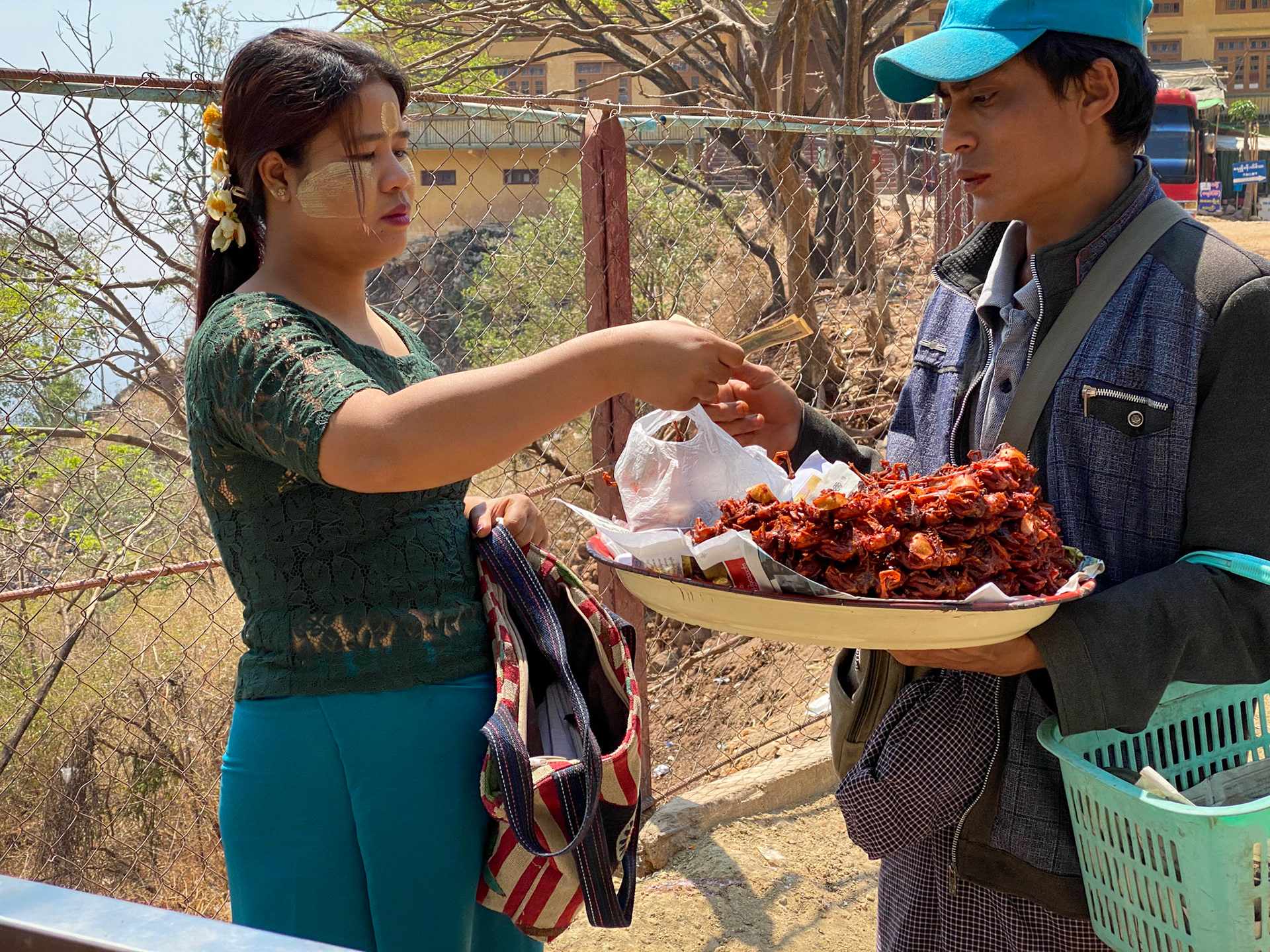 Our friend buying fried quails to munch on the way back