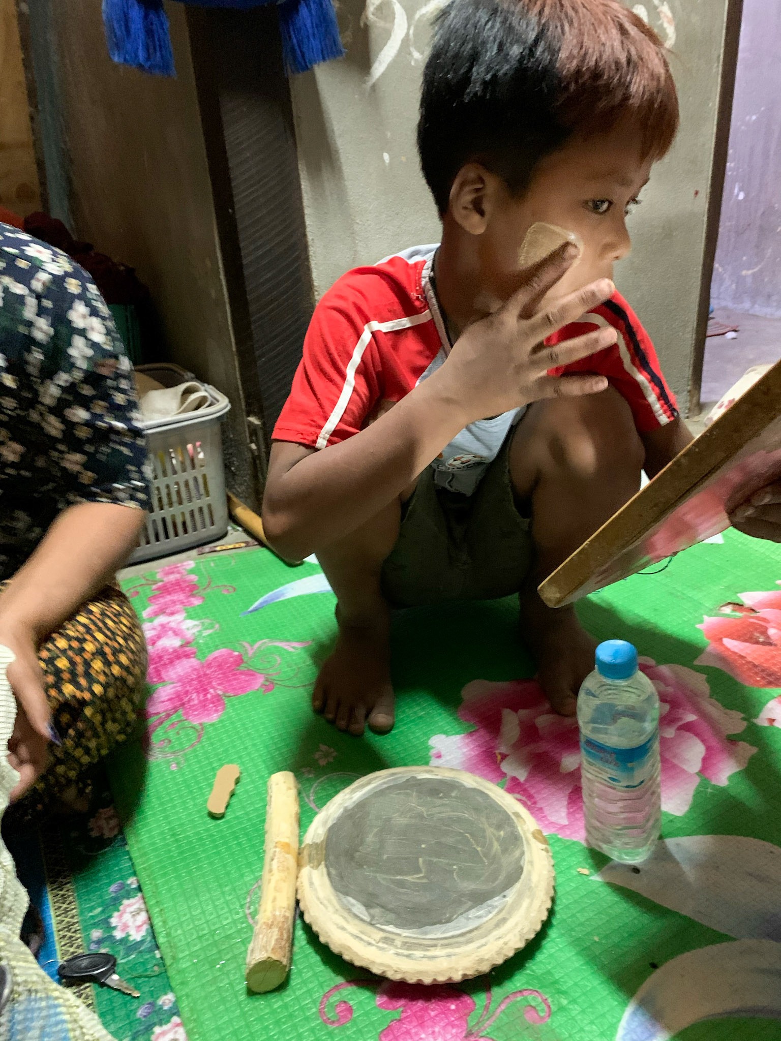 ATZ's son showing us how to use Thanaka: they pour a little bit of water on this grinding stone and then grind the Thanaka wood on it. It’s pretty and the perfume is really nice.