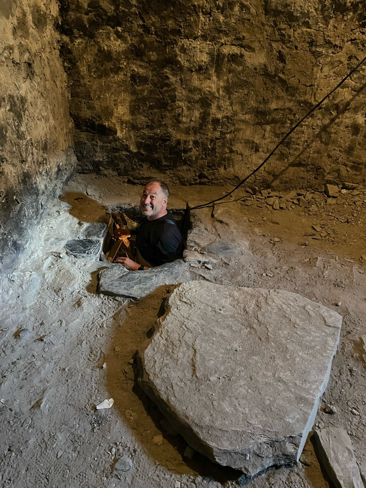 To block access in case of an attack, they would remove the ladder and place a massive stone on top of it. It is so big that it must have been installed during the construction, as it does not fit through the hatch.