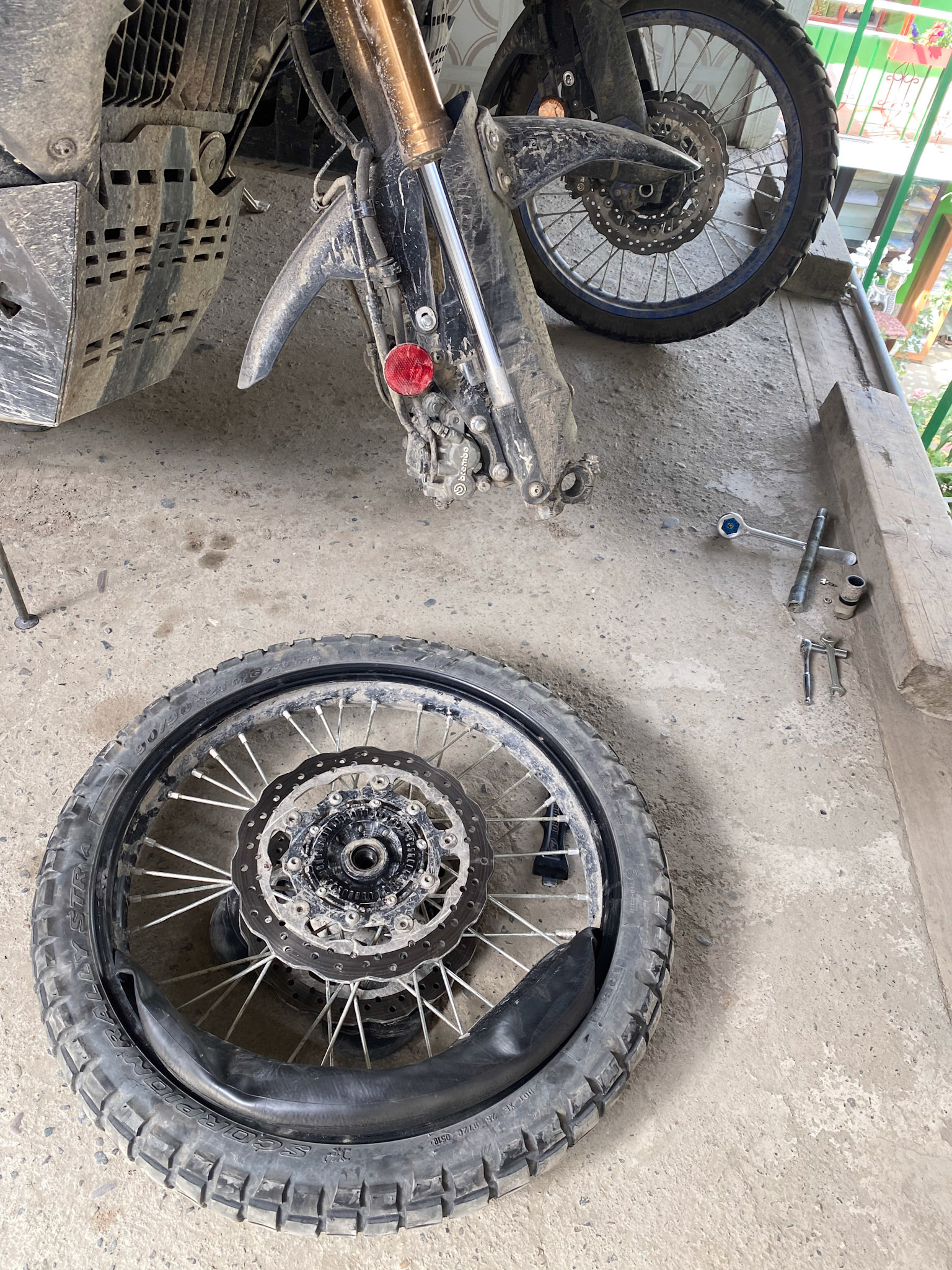 Swapping tires. I can finally get rid of the front tire I've been carrying since the Kosovo.