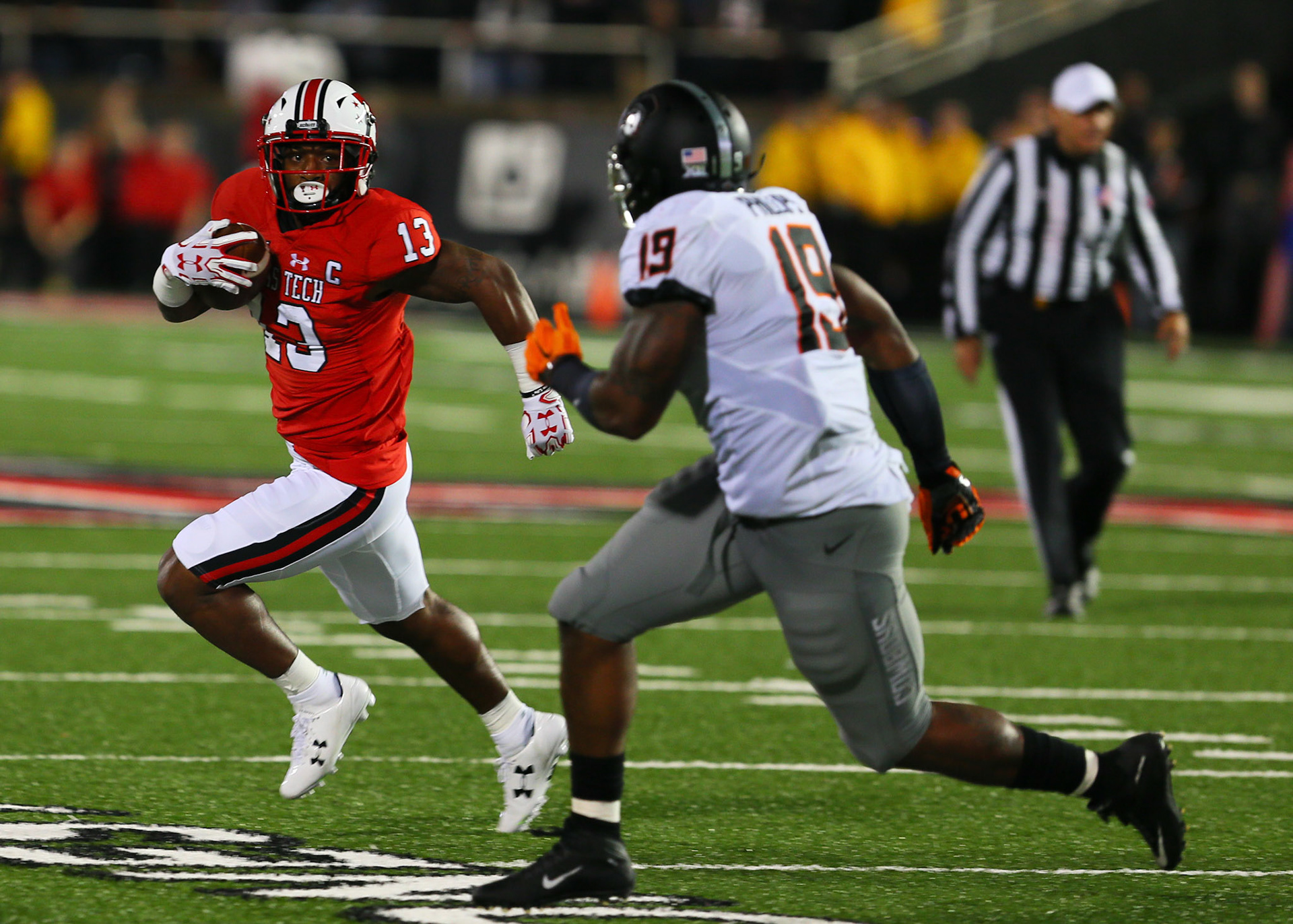 LUBBOCK, TX - SEPTEMBER 30: Texas Tech wide receiver Cameron Batson (13) is chased by Oklahoma State linebacker Justin Phillips (19) during the Texas Tech Raider's 41-34 loss to the Oklahoma State Cowboys on September 30, 2017 at Jones AT&amp;T Stadium in Lubbock, TX. (Photo by Sam Grenadier/Icon Sportswire)