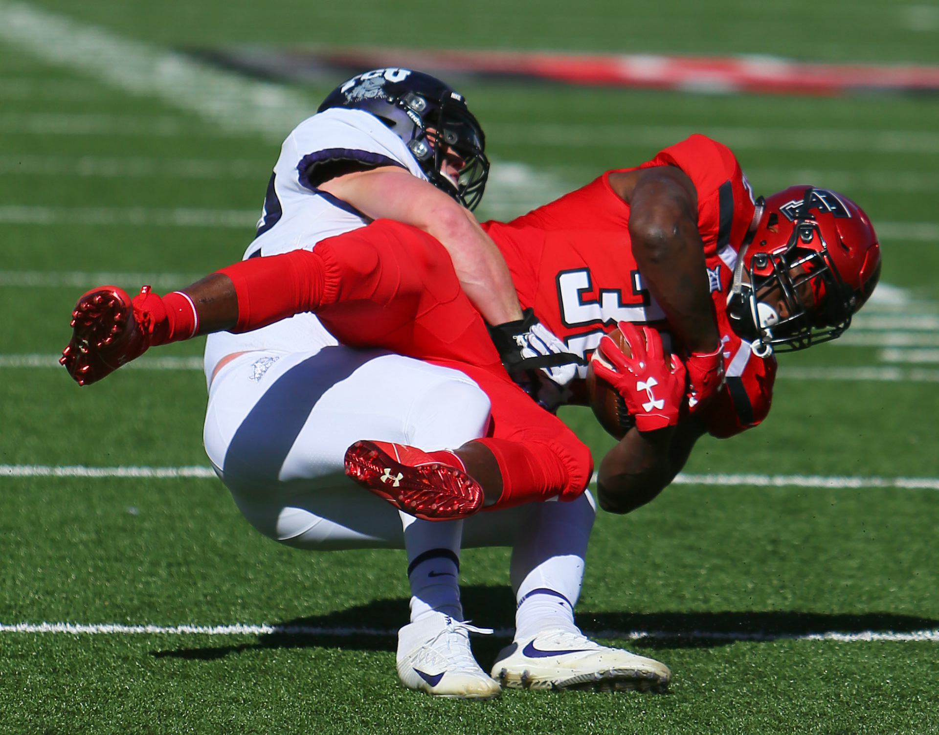LUBBOCK, TX - NOVEMBER 18: Texas Tech running back Desmond Nisby (32)  is tackled during the Texas Tech Raider's 27-3 loss to the Texas Christian University Horned Frogs on November 18, 2017 at Jones AT&amp;T Stadium in Lubbock, TX. (Photo by Sam Grenadier/Icon Sportswire)