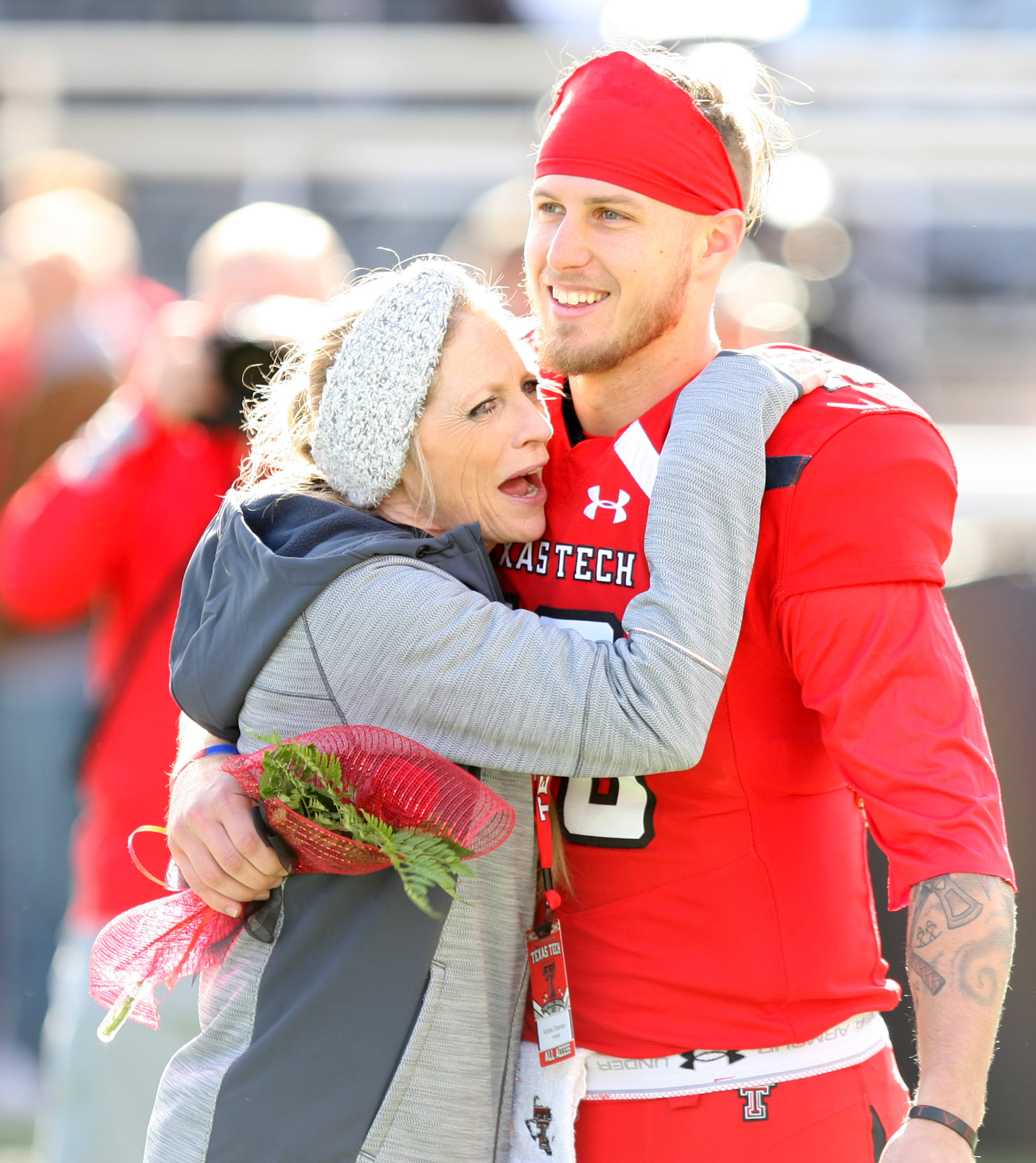LUBBOCK, TX - NOVEMBER 18: Texas Tech quarterback Nic Shimonek (16) hugs administrative assistant to the head coach Kirstie Sherman as he is introduced during the senior day ceremony before the Texas Tech Raider's 27-3 loss to the Texas Christian University Horned Frogs on November 18, 2017 at Jones AT&amp;T Stadium in Lubbock, TX. (Photo by Sam Grenadier/Icon Sportswire)