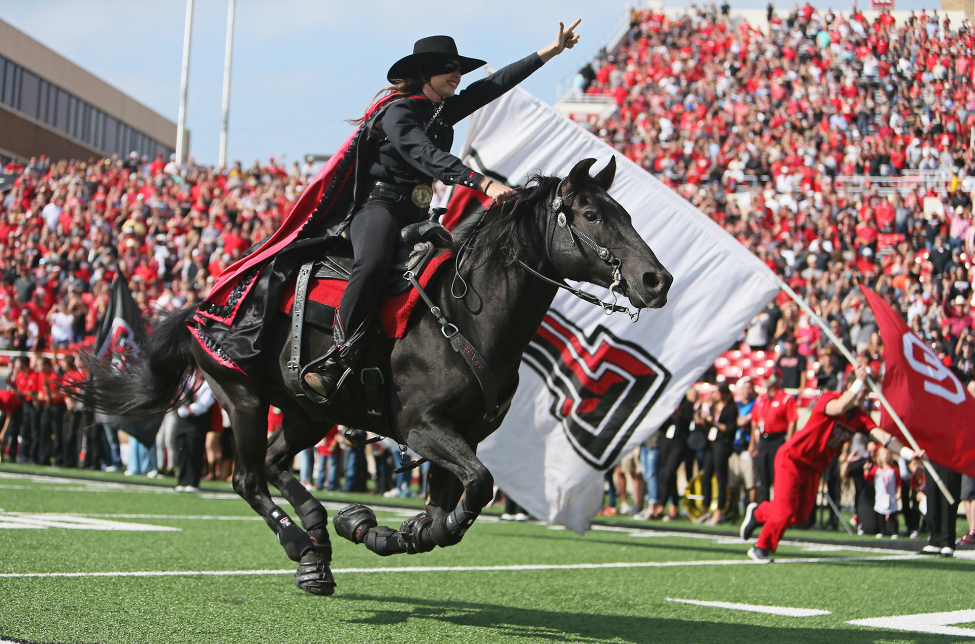 The Masked Rider leads the team onto the field before the game against West Virginia Saturday, Sept. 29, 2018, at Jones AT&amp;T Stadium in Lubbock, Texas. [Sam Grenadier/A-J Media]