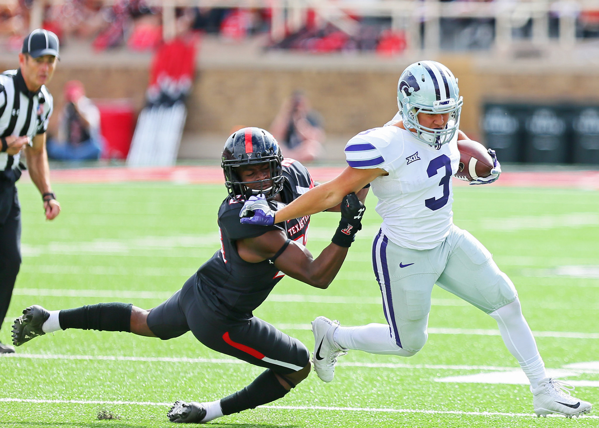 LUBBOCK, TX - NOVEMBER 04: Kansas State running back Dalvin Warmack (3) stiffarms a Texas Tech defender during the Texas Tech Raider's 42-35 loss to the Kansas State Wildcats on November 4, 2017 at Jones AT&amp;T Stadium in Lubbock, TX. (Photo by Sam Grenadier/Icon Sportswire)