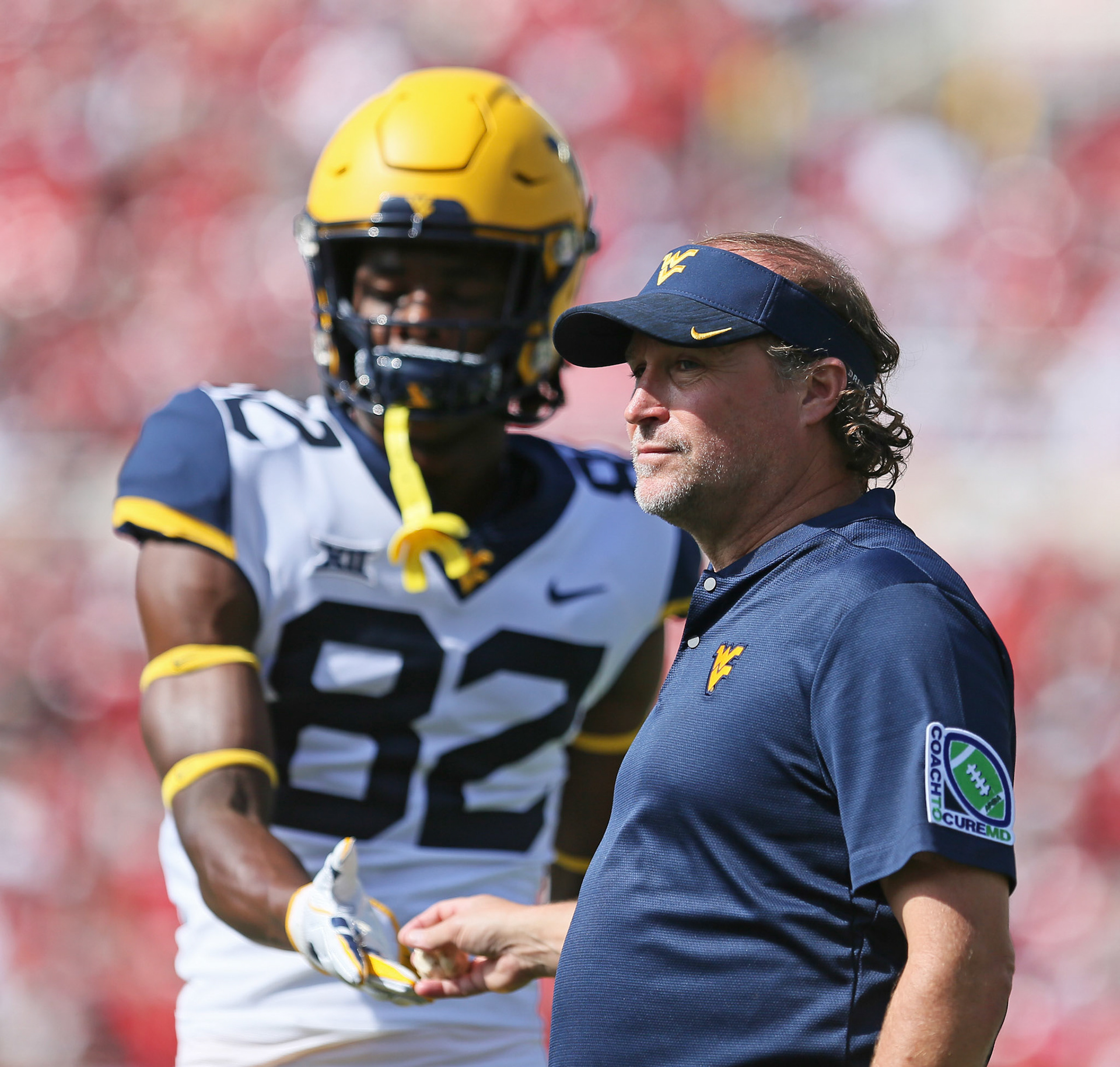 West Virginia's Dominique Maiden (82) hands a balled up tortilla to head coach Dana Holgorsen during game against West Virginia Saturday, Sept. 29, 2018, at Jones AT&amp;T Stadium in Lubbock, Texas. [Sam Grenadier/A-J Media]