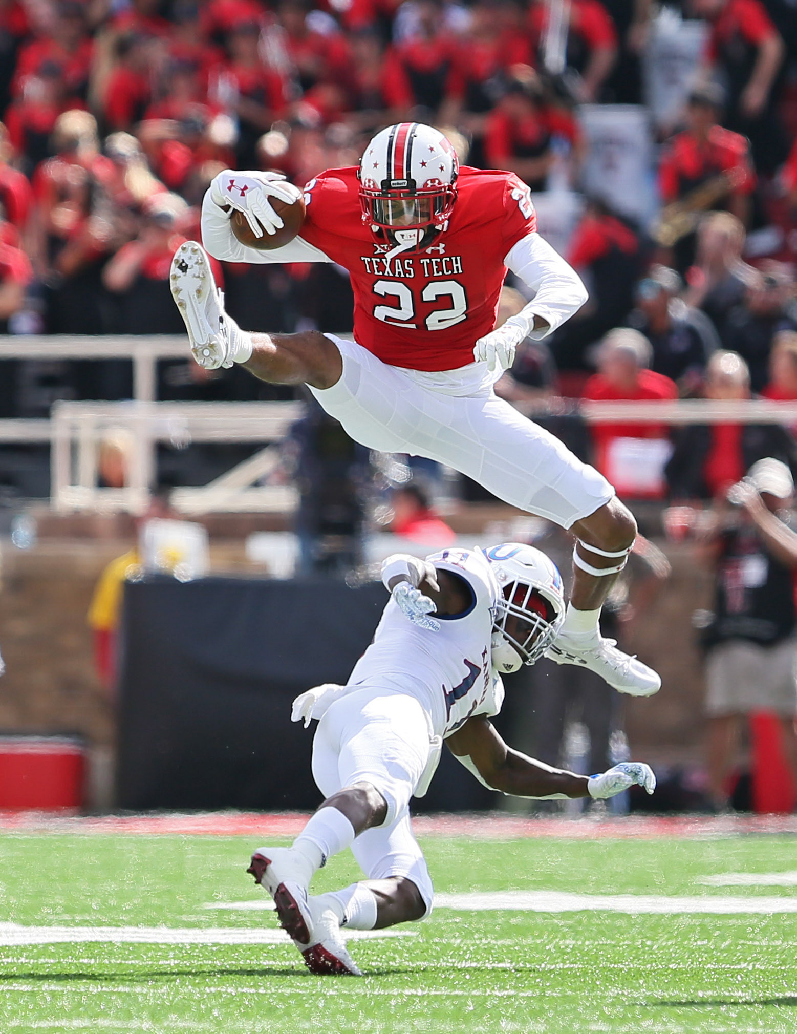 Texas Tech's Seth Collins (22) hurdles a defender during game against Kansas Saturday, Oct. 20, 2018, at Jones AT&amp;T Stadium in Lubbock, Texas. [Sam Grenadier/A-J Media]