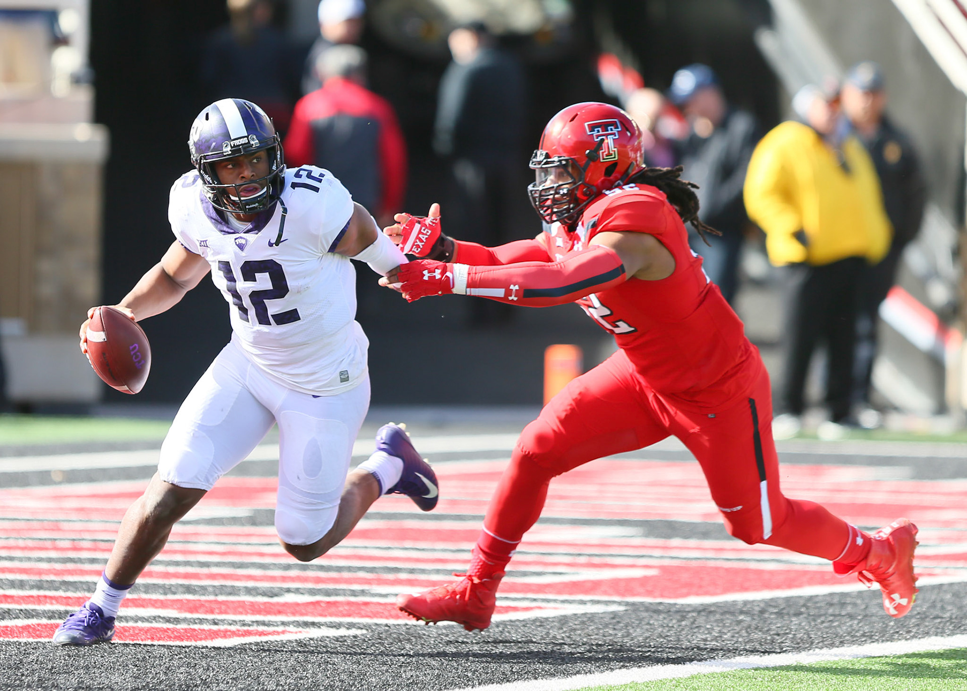 LUBBOCK, TX - NOVEMBER 18: Texas Christian quarterback Shawn Robinson (12) evades a tackle during the Texas Tech Raider's 27-3 loss to the Texas Christian University Horned Frogs on November 18, 2017 at Jones AT&amp;T Stadium in Lubbock, TX. (Photo by Sam Grenadier/Icon Sportswire)