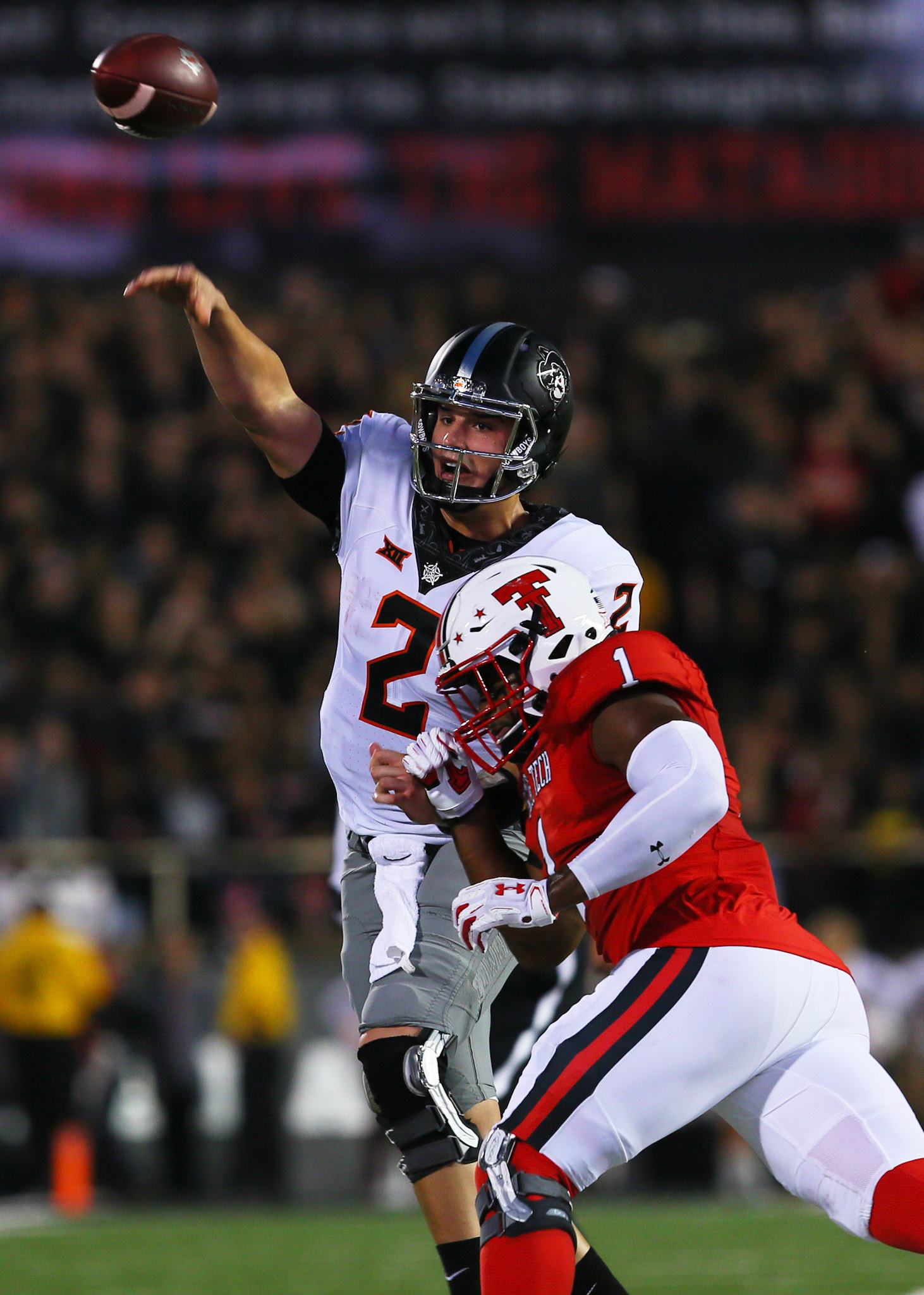 LUBBOCK, TX - SEPTEMBER 30: Oklahoma State quarterback Mason Rudolph (2) throws as he is hit by Texas Tech linebacker Jordyn Brooks (1) during the Texas Tech Raider's 41-34 loss to the Oklahoma State Cowboys on September 30, 2017 at Jones AT&amp;T Stadium in Lubbock, TX. (Photo by Sam Grenadier/Icon Sportswire)