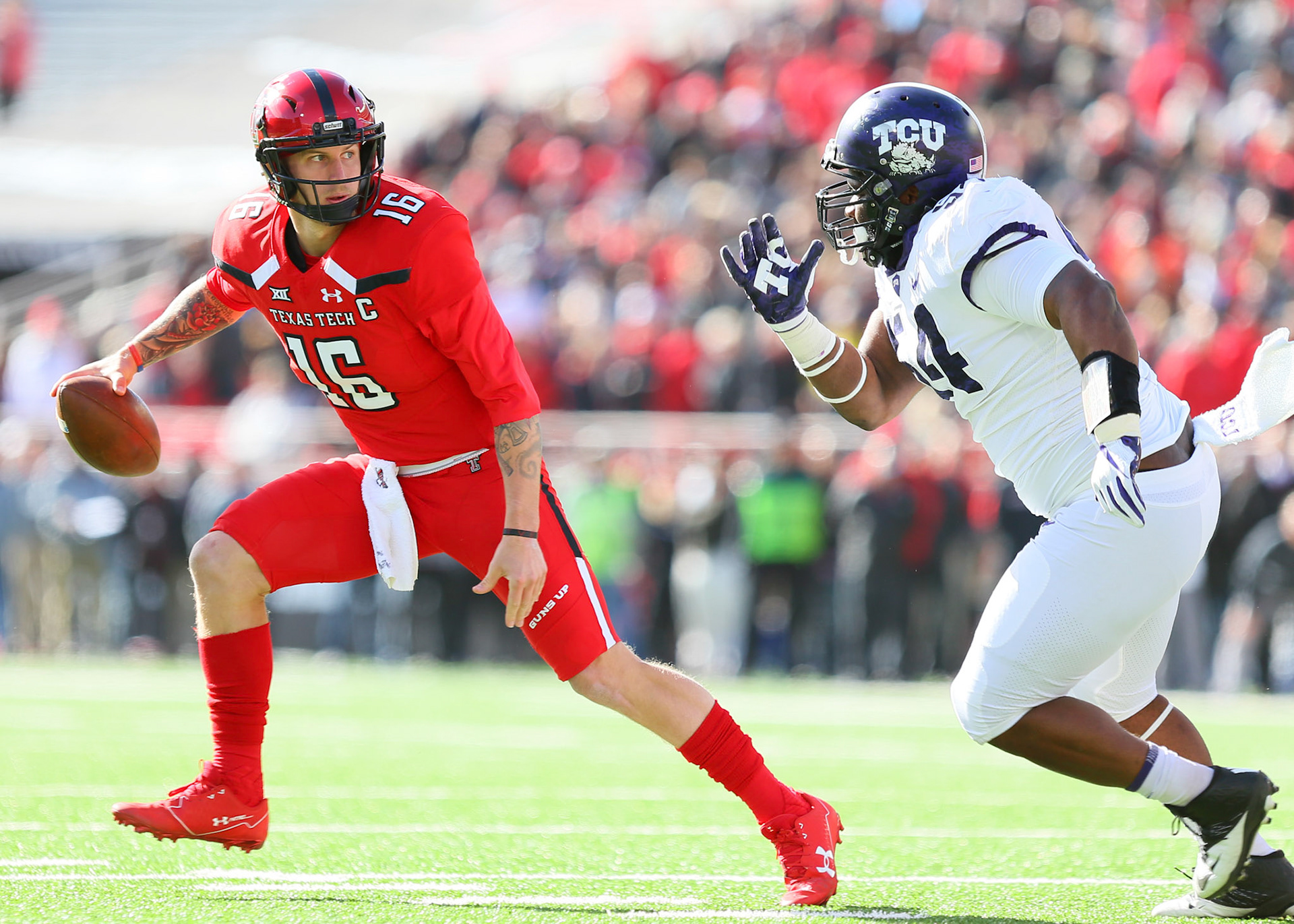 LUBBOCK, TX - NOVEMBER 18: Texas Tech quarterback Nic Shimonek (16) evades the tackle of Texas Christian defensive tackle Joseph Broadnax Jr. (54) during the Texas Tech Raider's 27-3 loss to the Texas Christian University Horned Frogs on November 18, 2017 at Jones AT&amp;T Stadium in Lubbock, TX. (Photo by Sam Grenadier/Icon Sportswire)