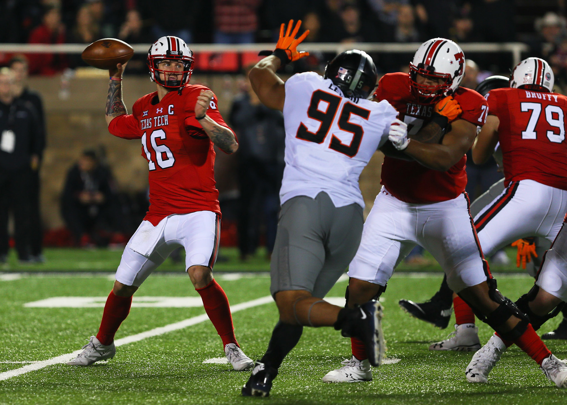 LUBBOCK, TX - SEPTEMBER 30: Texas Tech quarterback Nic Shimonek (16) throws as he is pressured by Oklahoma State defensive end Vili Leveni (97) during the Texas Tech Raider's 41-34 loss to the Oklahoma State Cowboys on September 30, 2017 at Jones AT&amp;T Stadium in Lubbock, TX. (Photo by Sam Grenadier/Icon Sportswire)