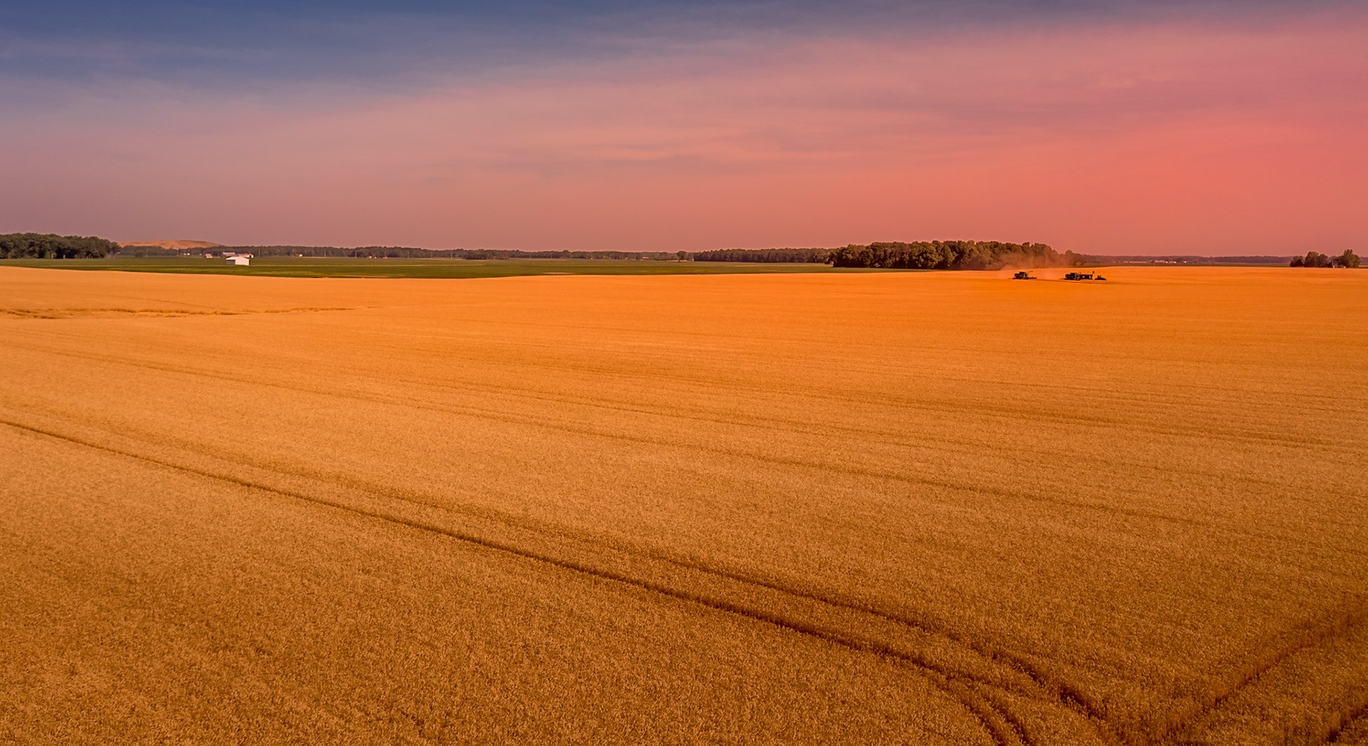 Farmers hard at work harvesting wheat on July 4, 2022 in Ohio