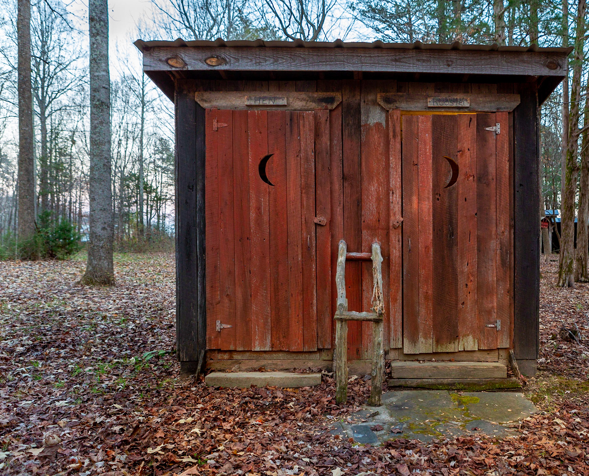 A side-by-side Hen and Rooster outhouse