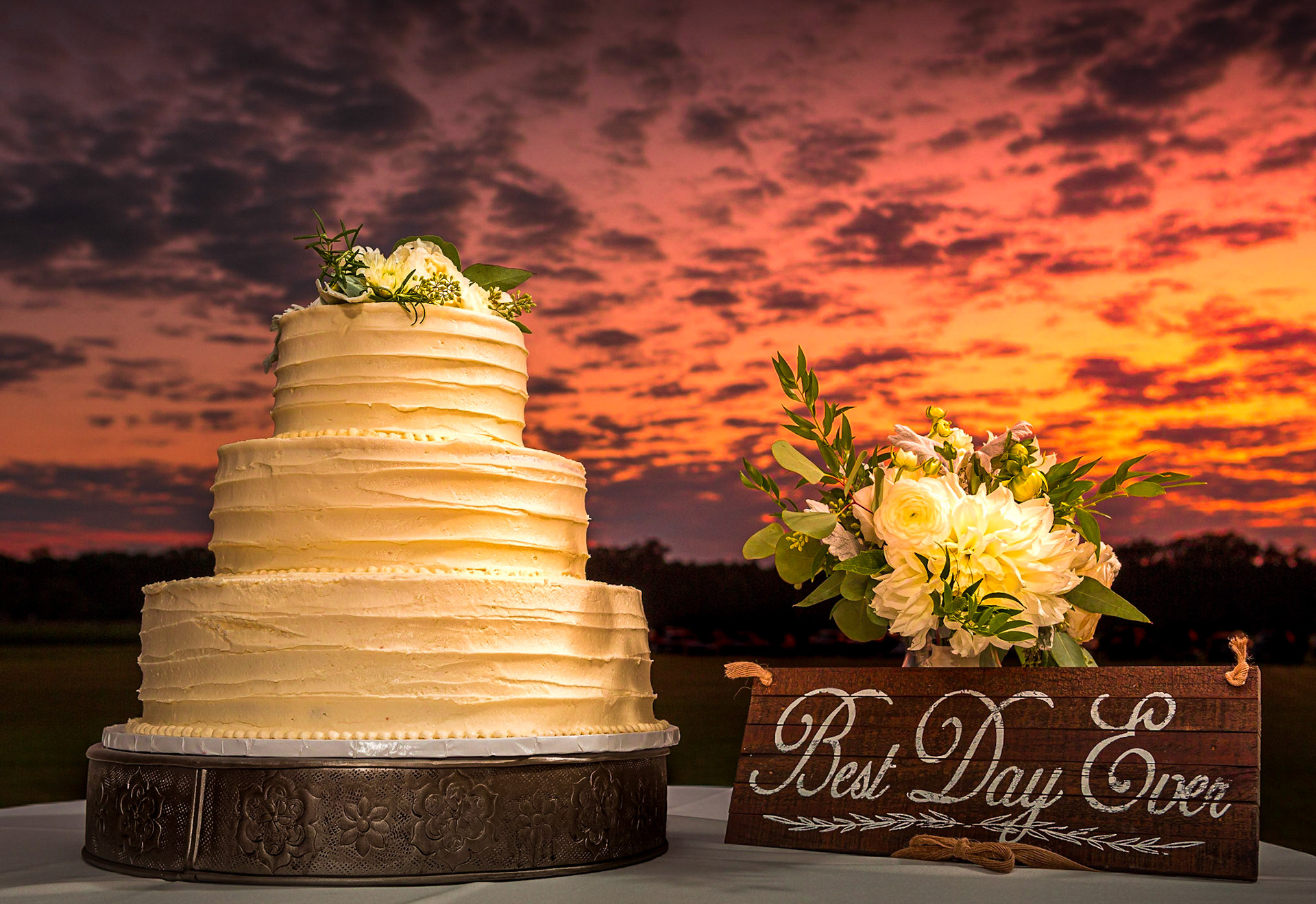 Wedding cake, flowers and a sunset