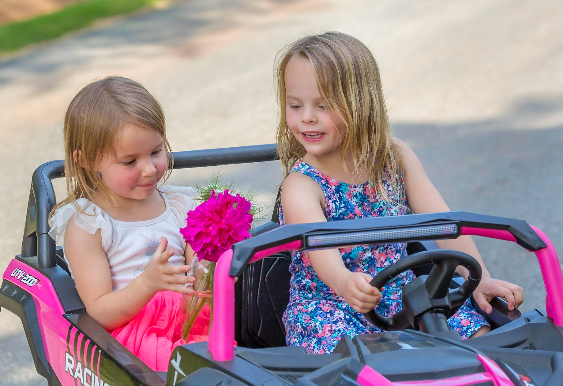 A flower, two beautiful young girls