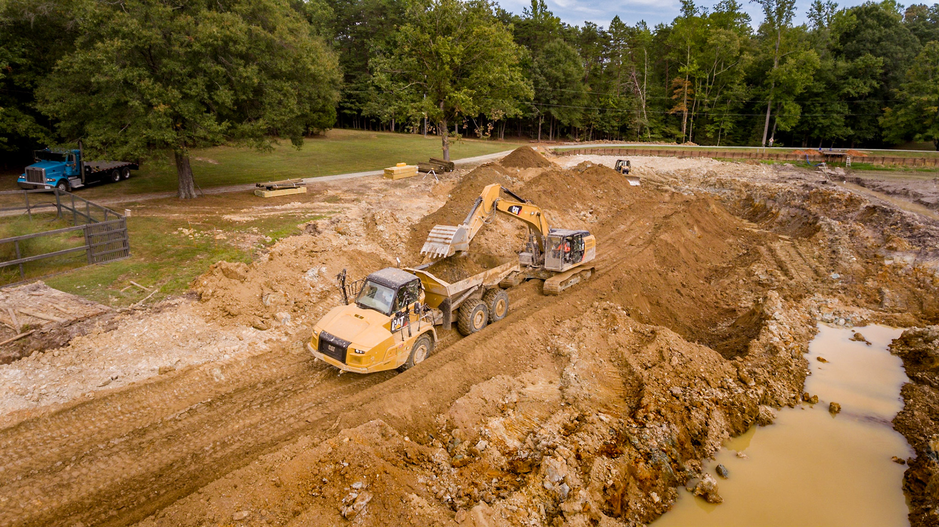 CAT 329 Excavator loading up the CAT 725 off road 6x6 dump truck