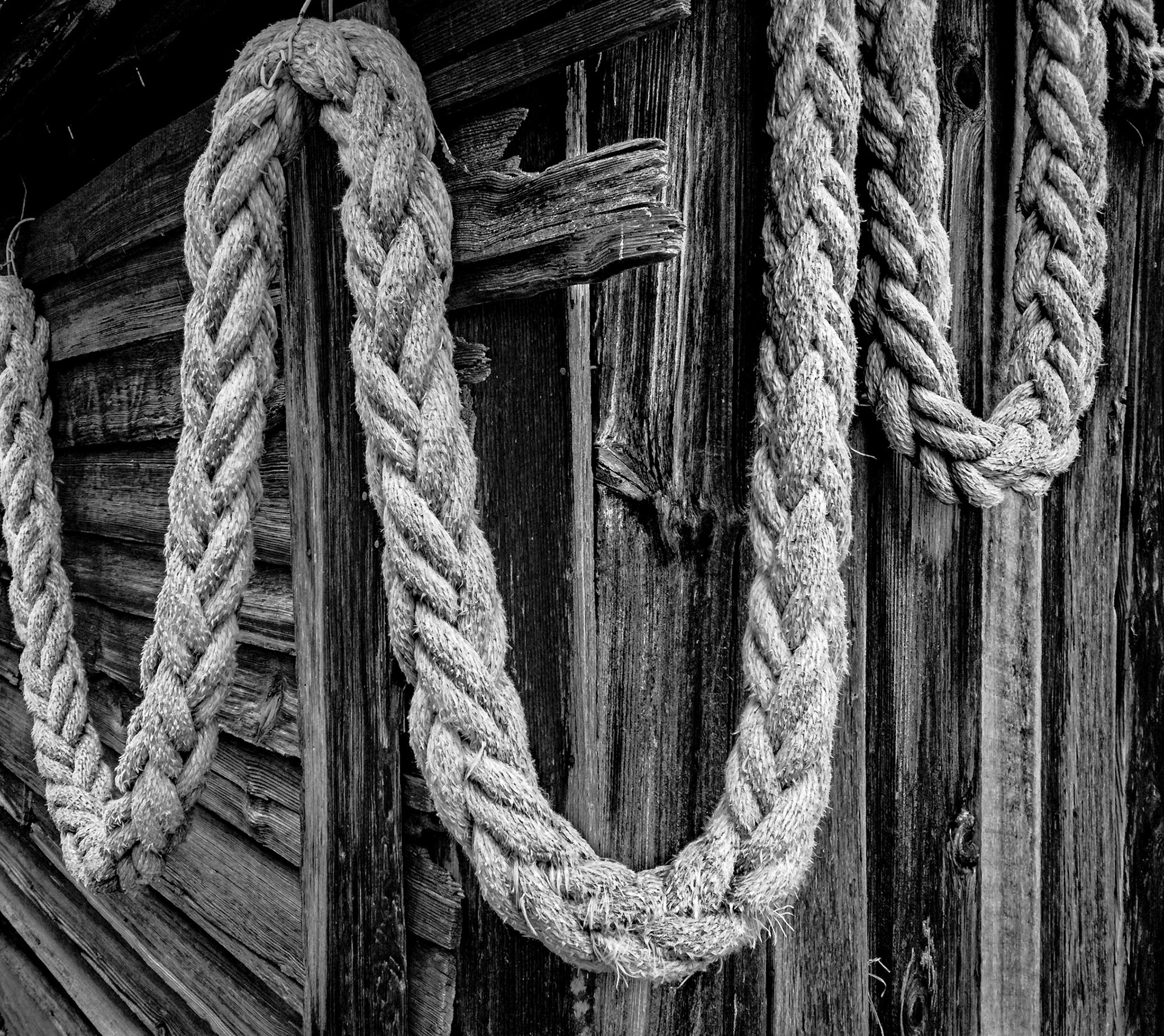 A large rope drapped around an old out building