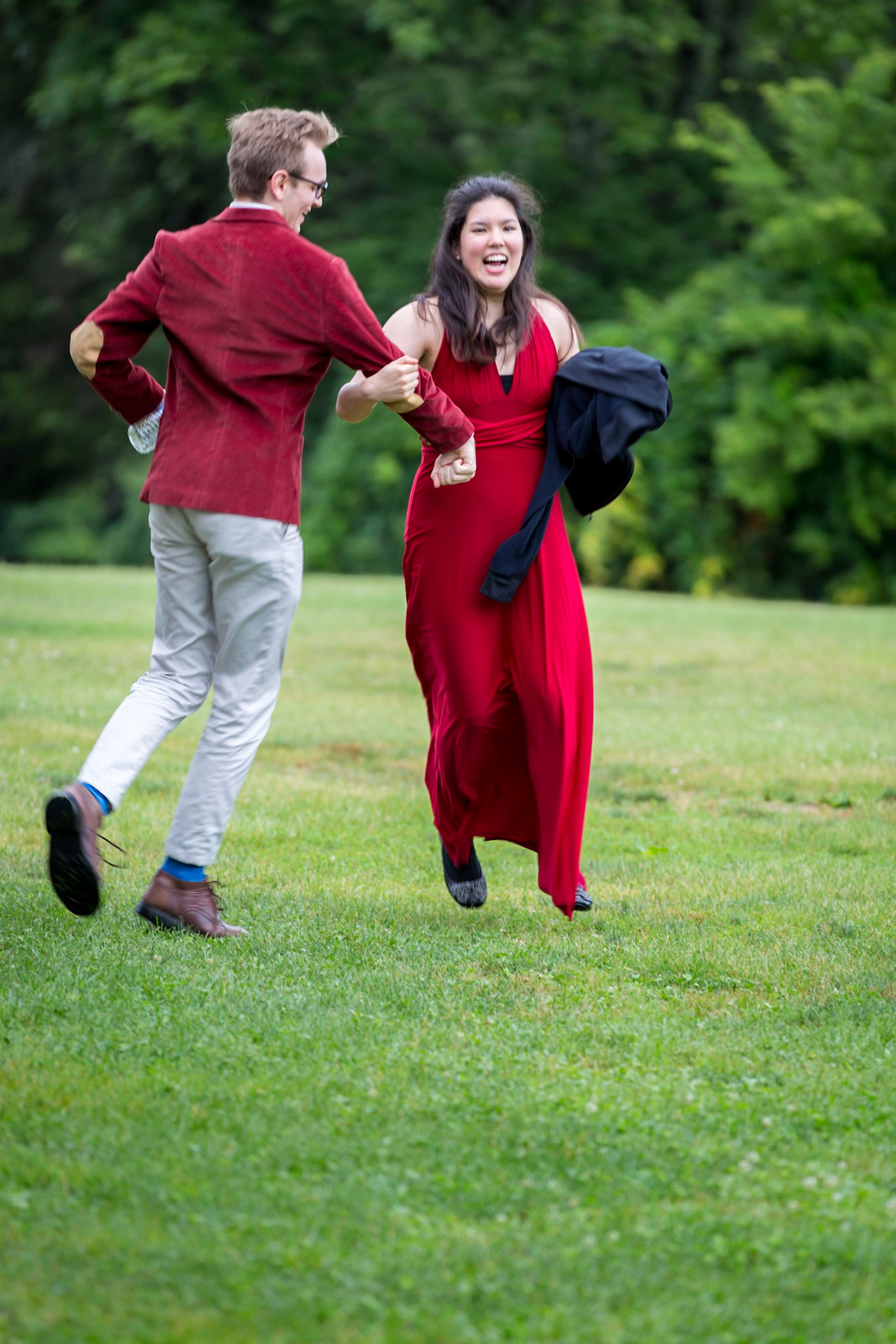 A couple in red dancing in the grass