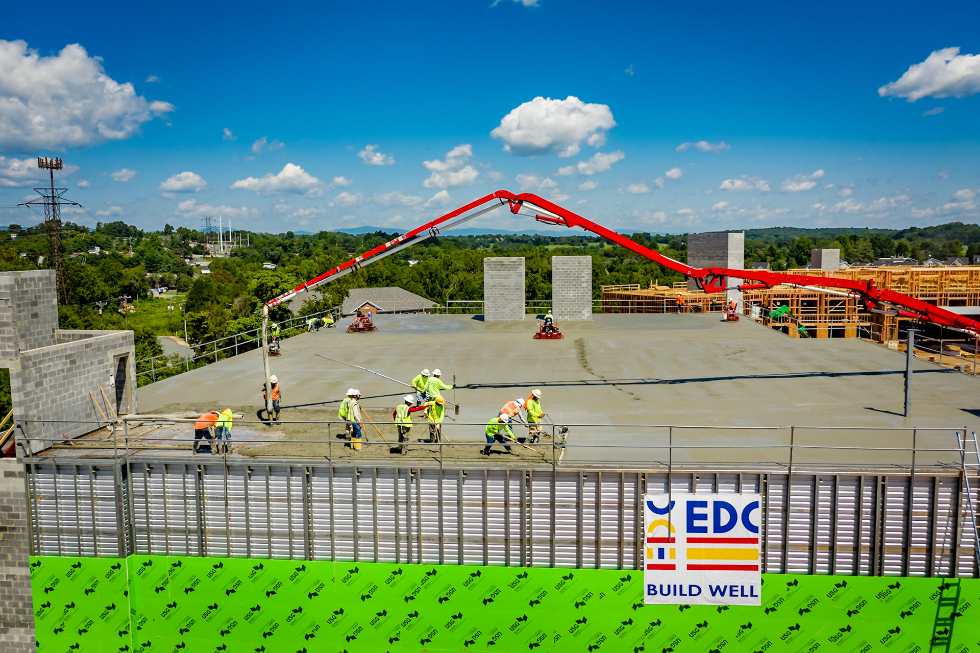 Concrete pump truck delivering the last of the concrete and finishers starting to finish the concrete poured earlier