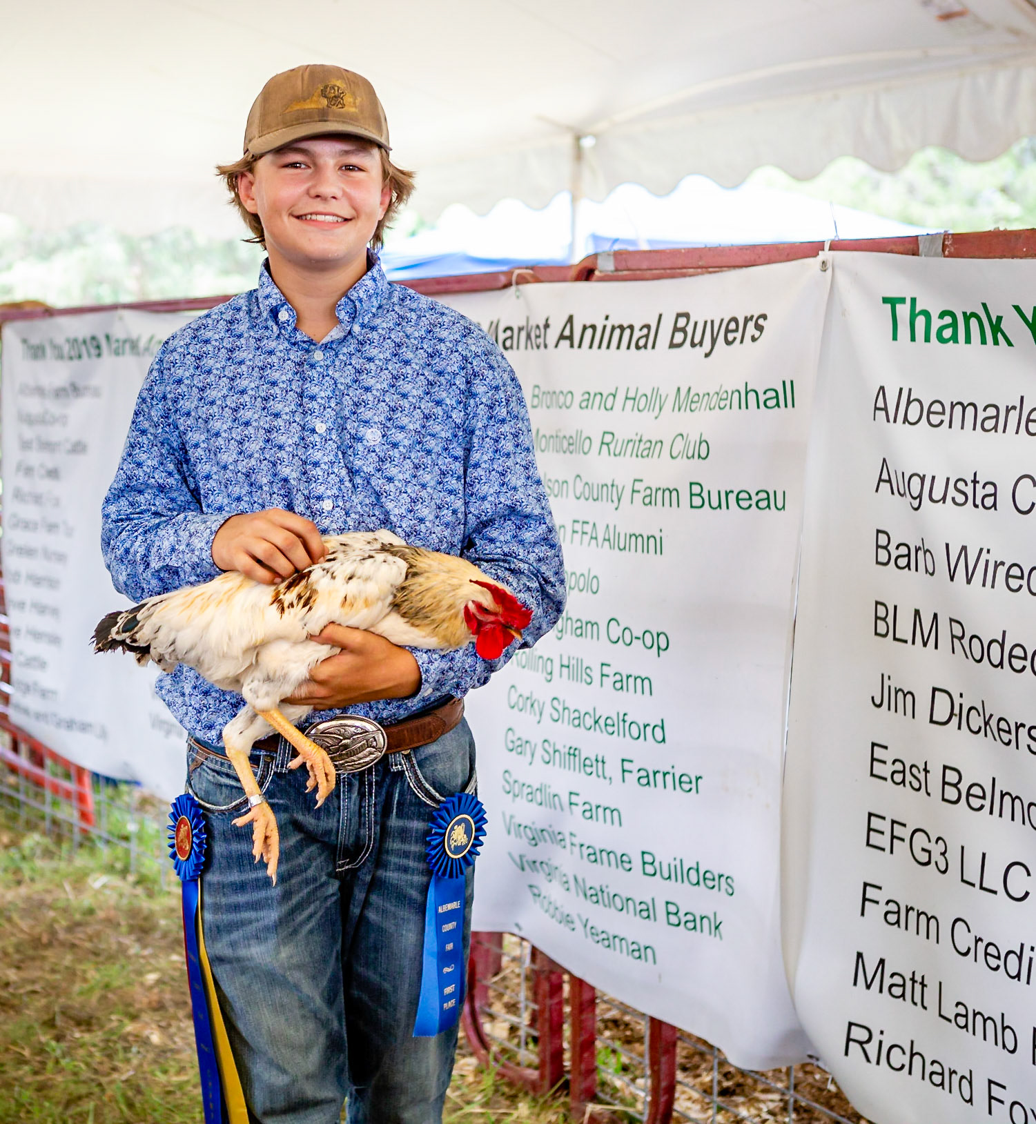 A proud young farmer with his chicken
