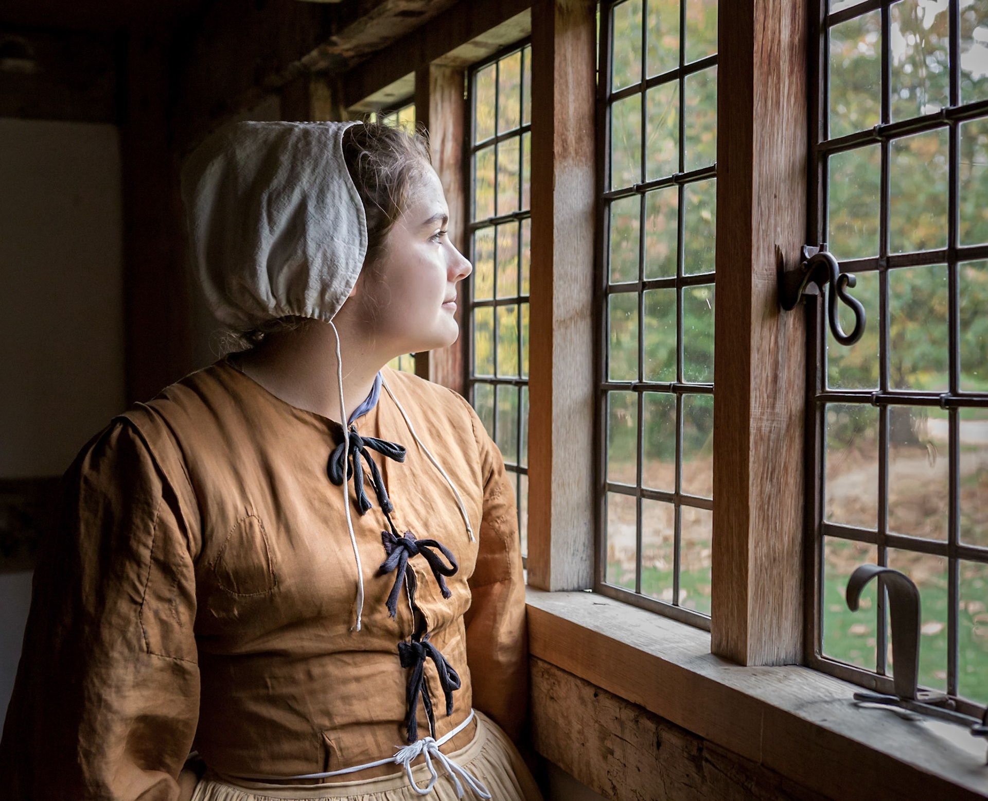 Woman looking out window at the Frontier Culture Museum